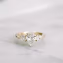 18k yellow gold three stone ring featuring pear shape lab grown diamonds