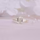 Yellow Gold 2ct Emerald Cut and Pear Three Stone Manmade Diamond Ring Ada Diamonds Design AD-467 Artistic Image