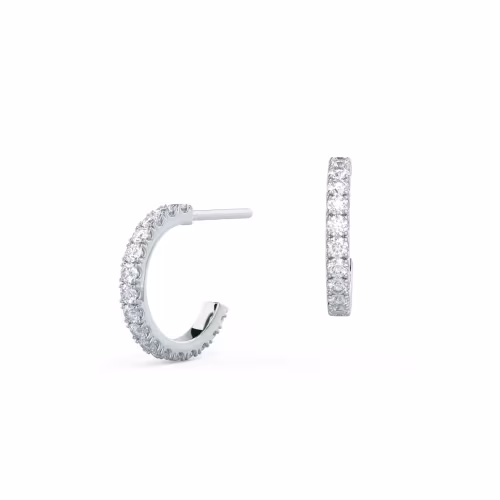 A pair of J-shaped huggie hoops featuring pave set lab created diamonds with a tension back in 14k White Gold.