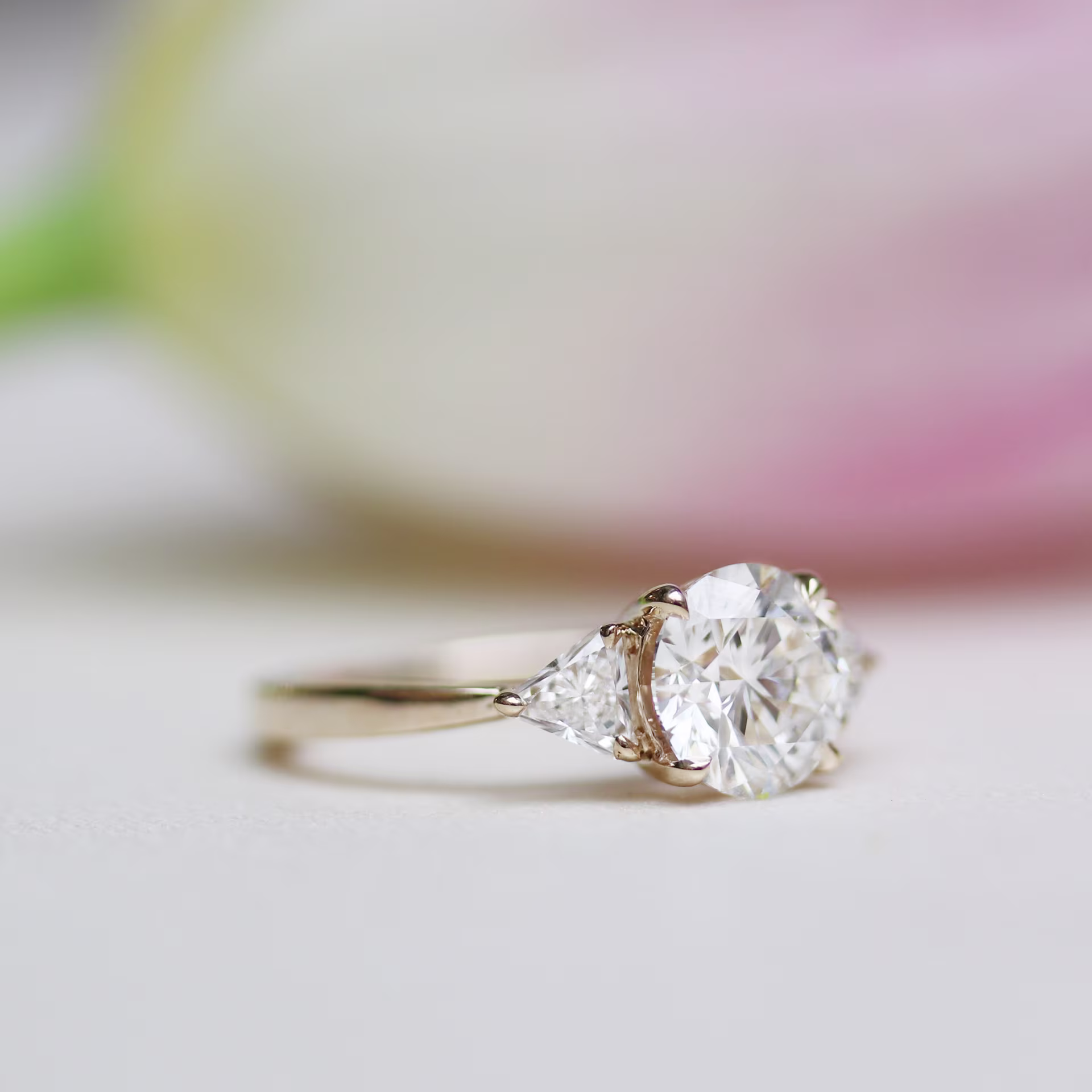 round and trillion three stone lab diamond engagement ring in yellow gold