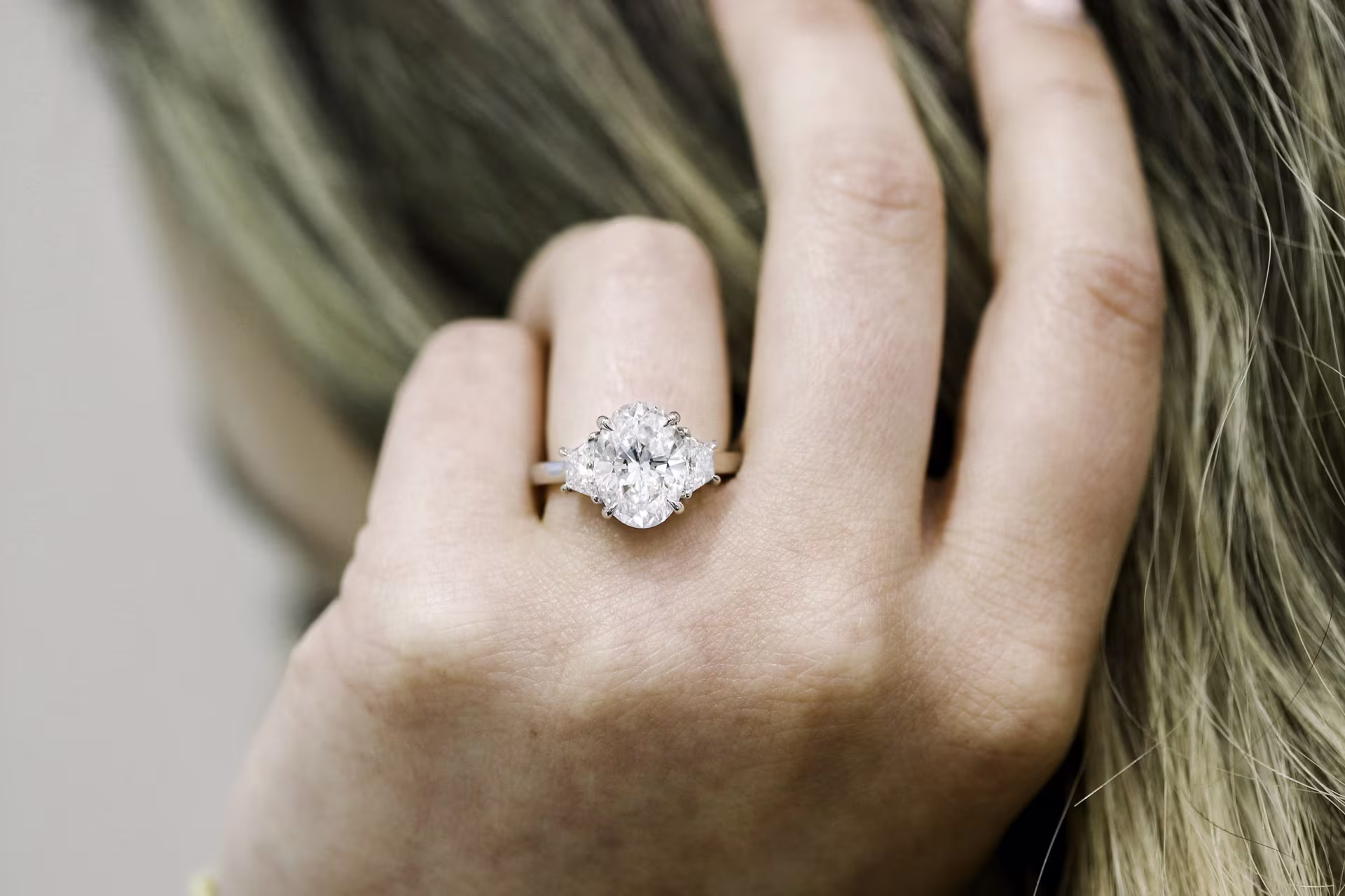 3.5carat oval lab diamond in three stone ring wiht half moon side stones