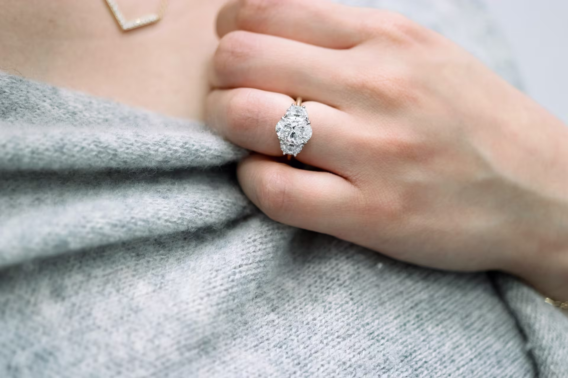 2.25ct oval with half moon side stones two tone