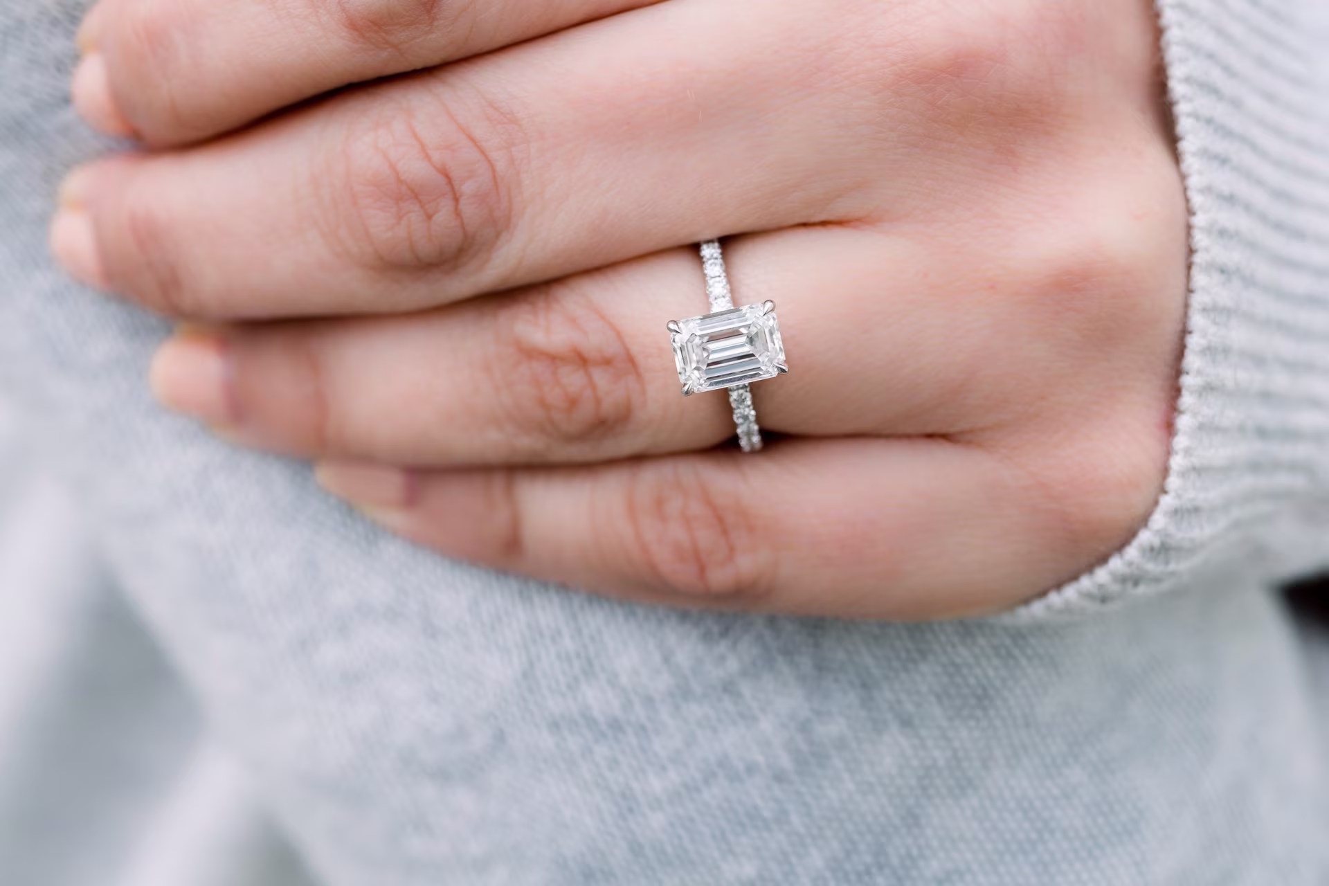 1.5ct emerald cut lab diamond in pave setting on model 