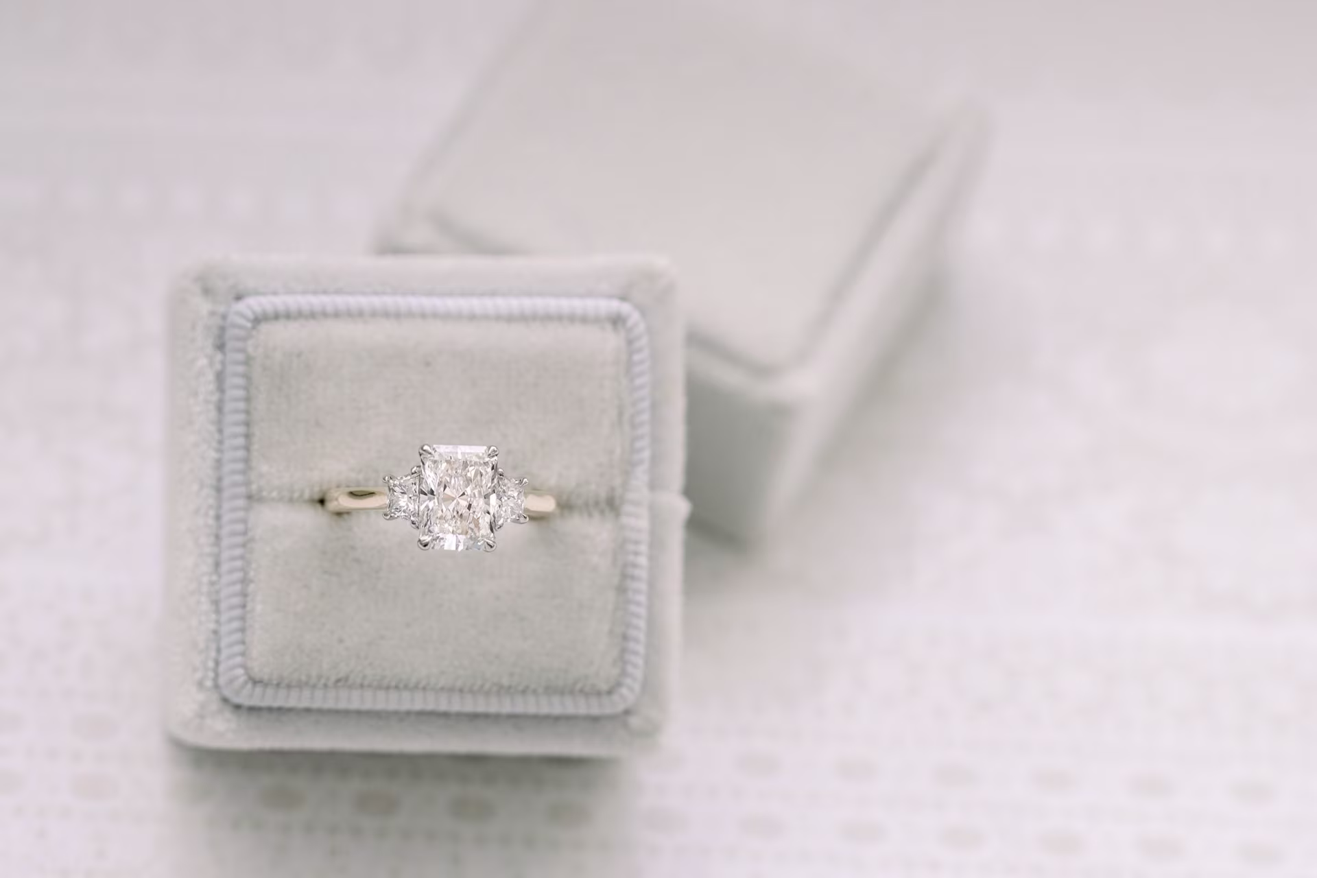 1.5ct radiant cut lab diamond in three stone setting