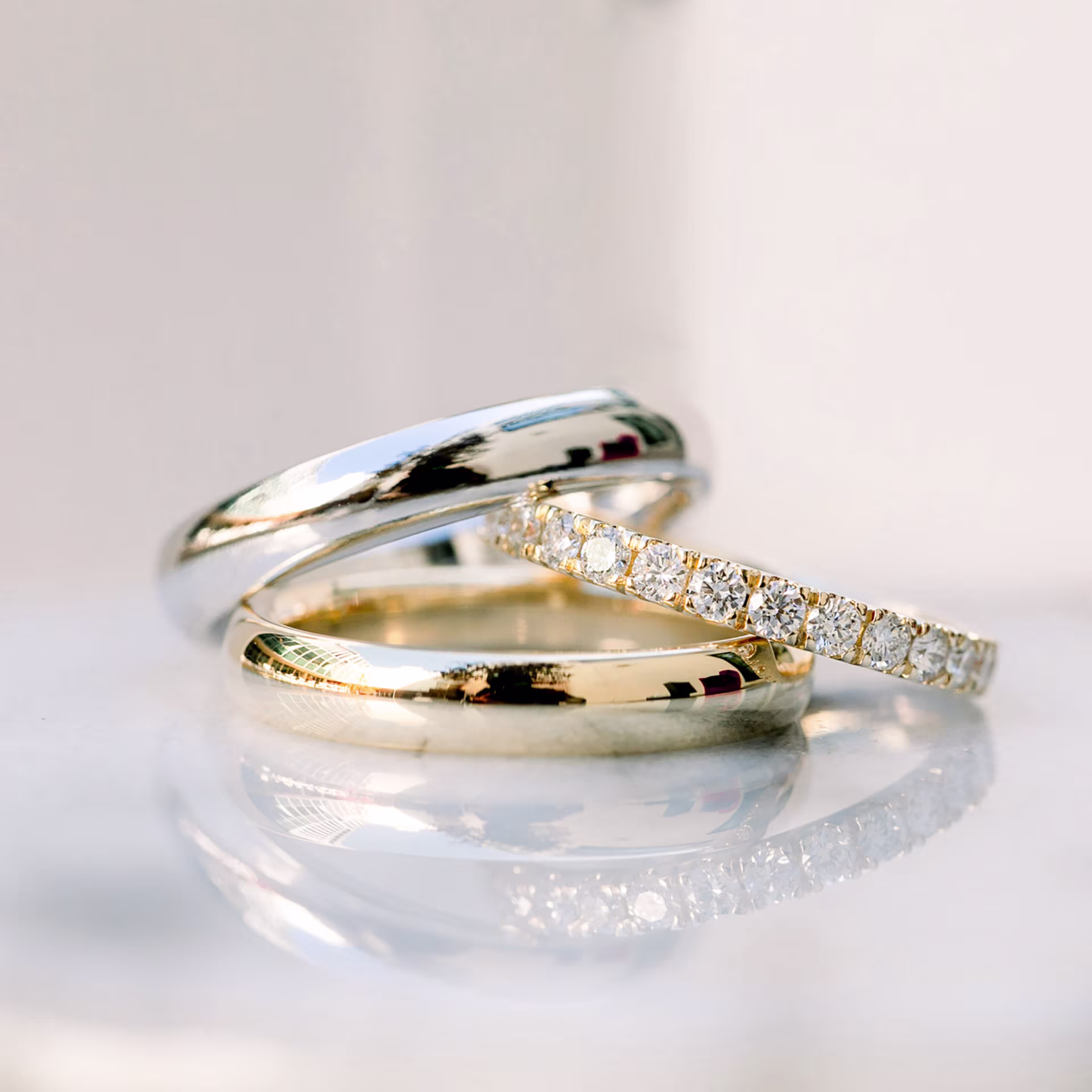 Classic Rounded Men's Wedding Band in White Gold and Yellow Gold with U Pavé Lab Diamond Eternity Band in Yellow Gold Ada Diamonds Design Number AD-168 and AD-082 Macro Shot