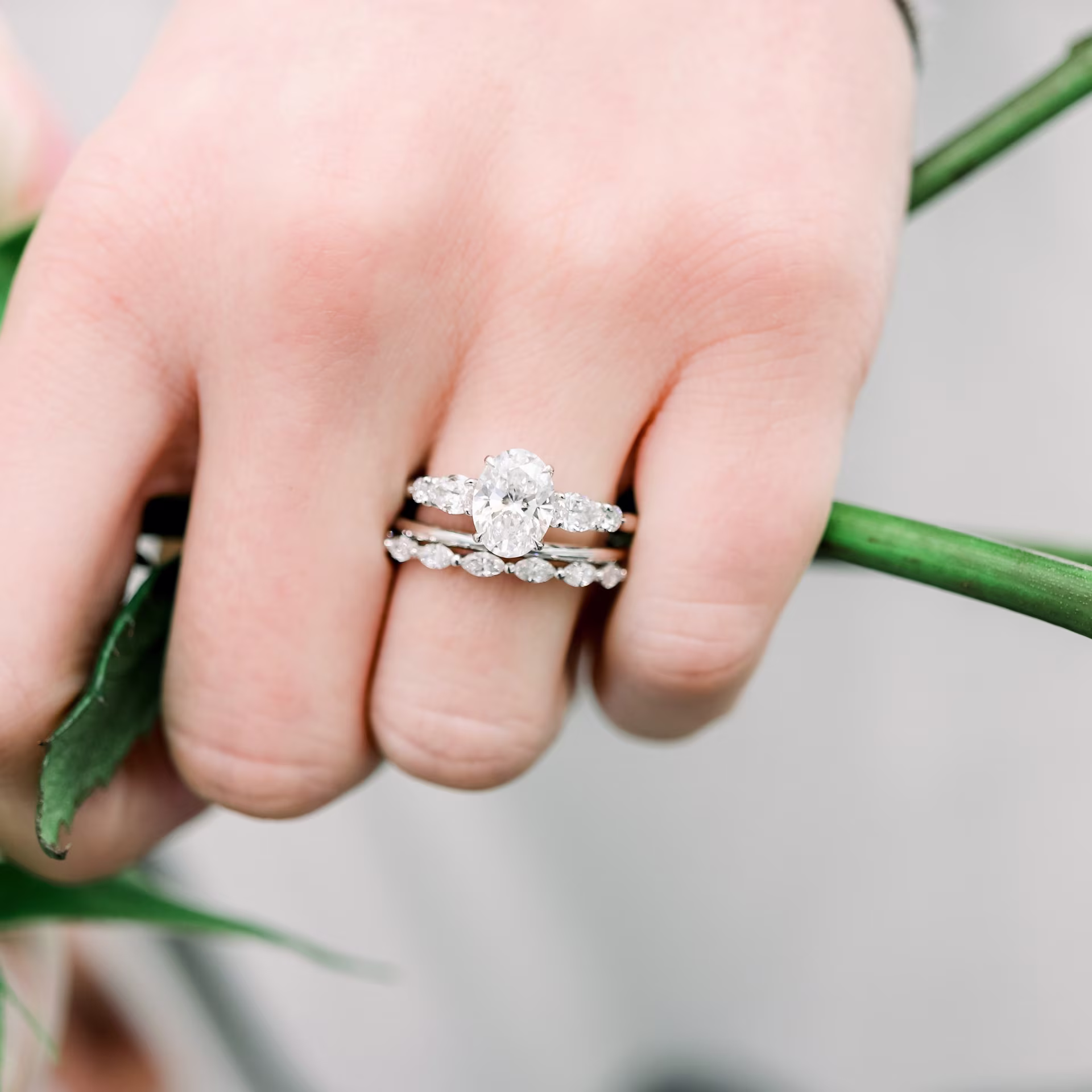 platinum custom 2.5ct oval and pear five stone lab diamond engagement ring with marquise wedding band and spacer band ada diamonds design ad 180 ad270 and ad295