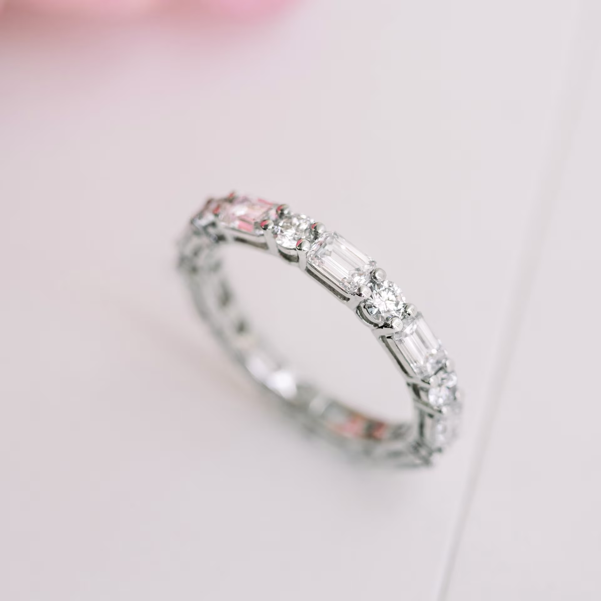 white gold emerald and round eternity band