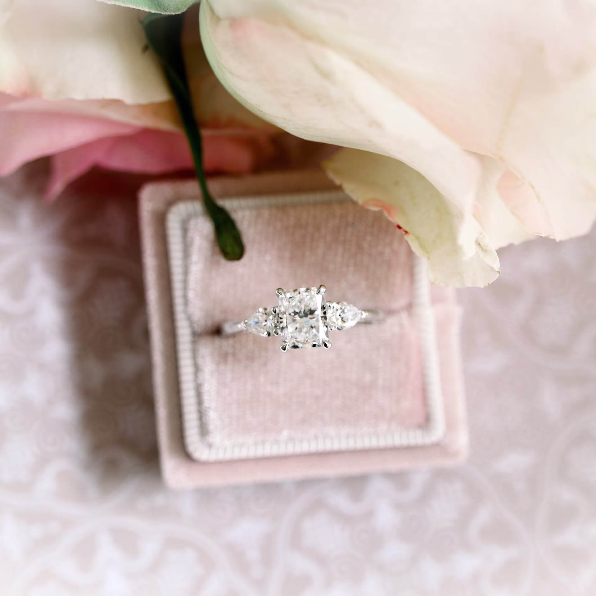 gia graded lab grown radiant diamond with pear side stones set in a white gold engagement ring