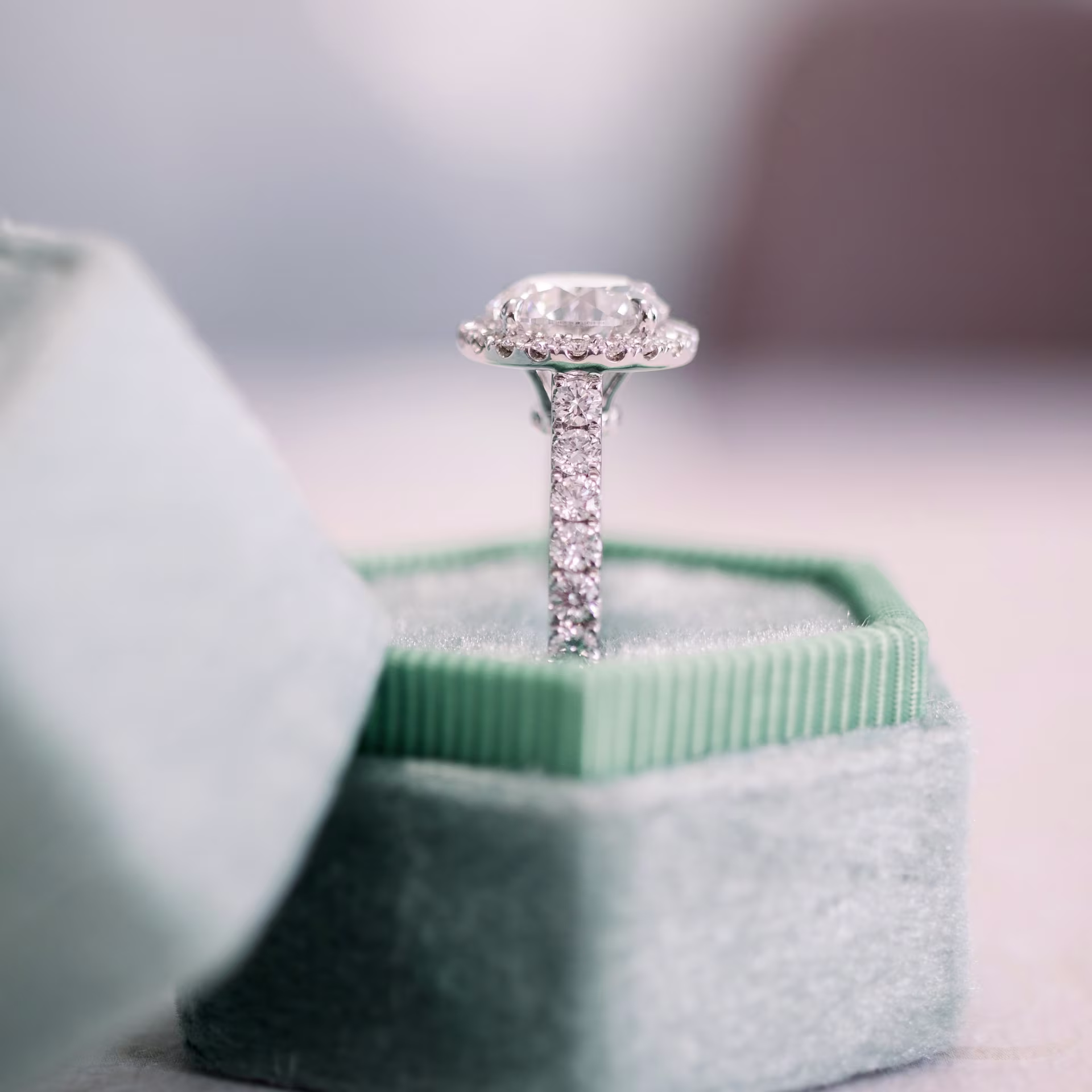 2.5ct round lab diamond in halo engagement ring with diamonds on the band in platinum