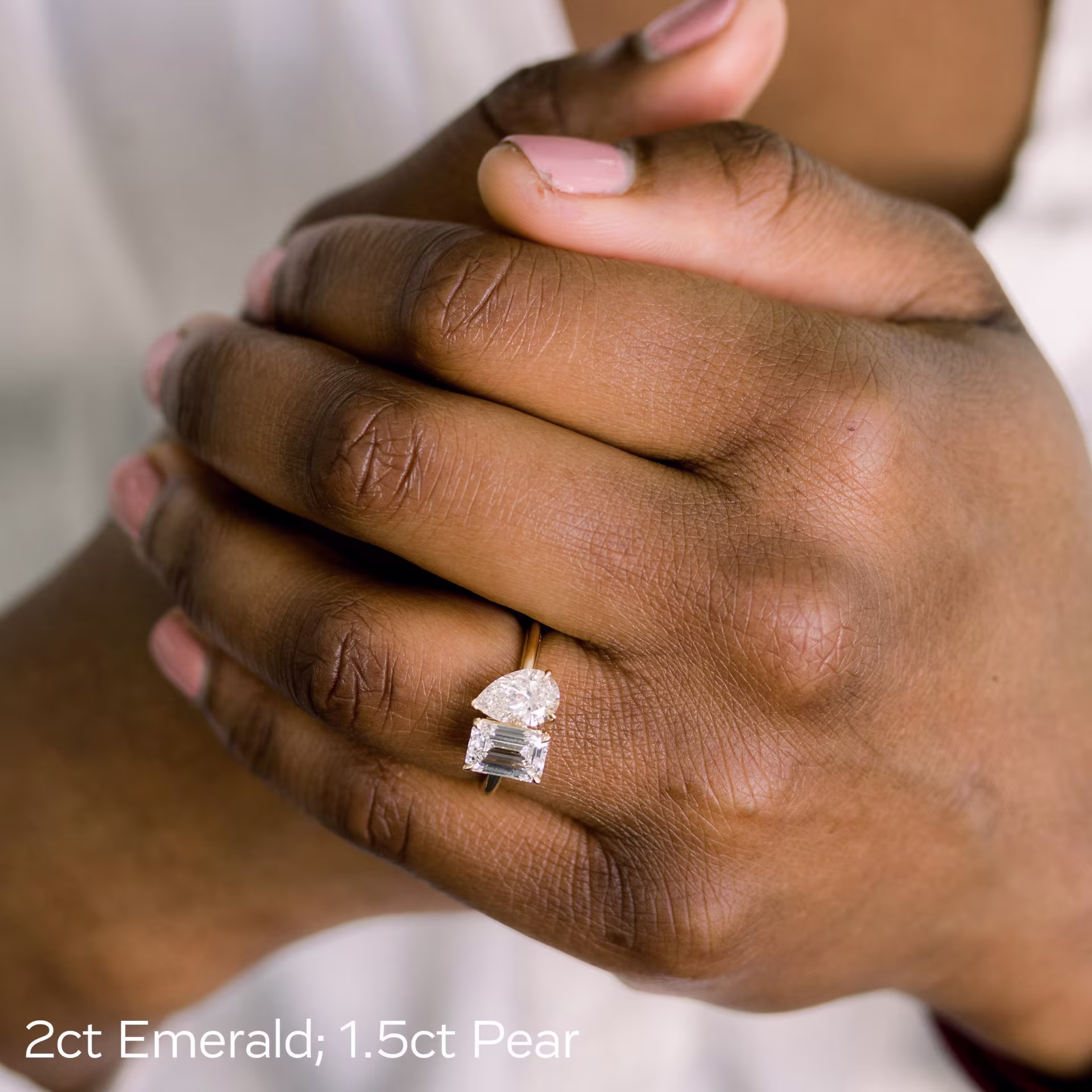 pear and emerald two stone man made diamond engagement ring in 18k yellow gold on model