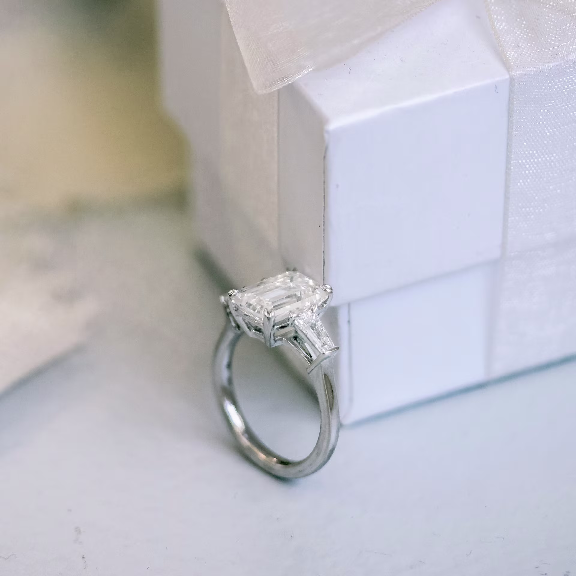 platinum four carat emerald cut and tapered baguette three stone lab diamond engagement ring ada diamonds design ad 464 profile view