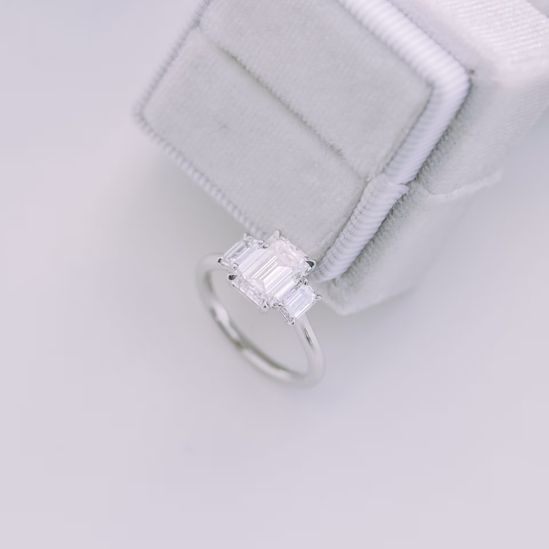 Platinum 2.25 carat emerald three stone lab diamond engagement ring with emerald side stones ada diamonds design ad-114