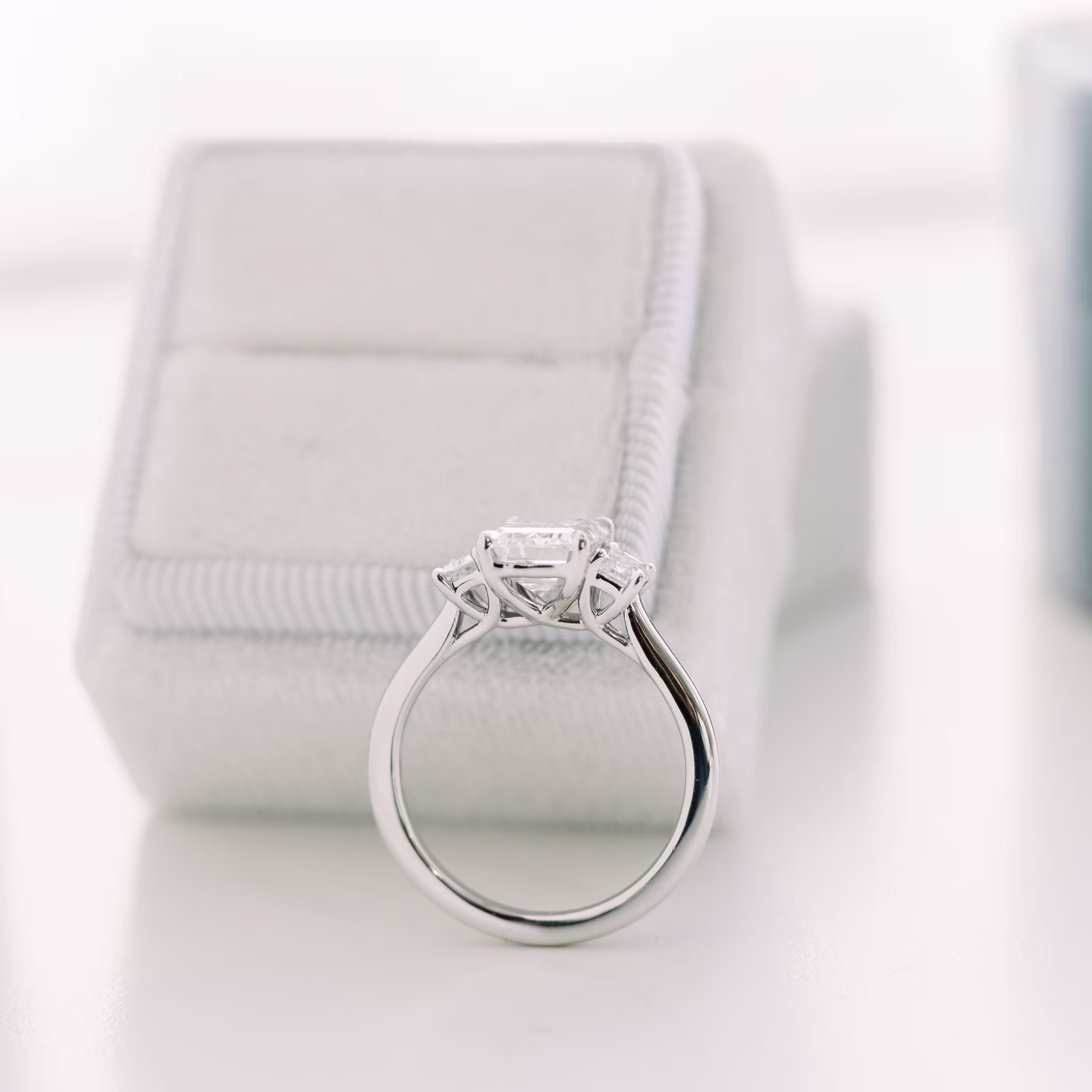 Platinum 2.25 carat emerald three stone lab diamond engagement ring with emerald side stones ada diamonds design ad-114