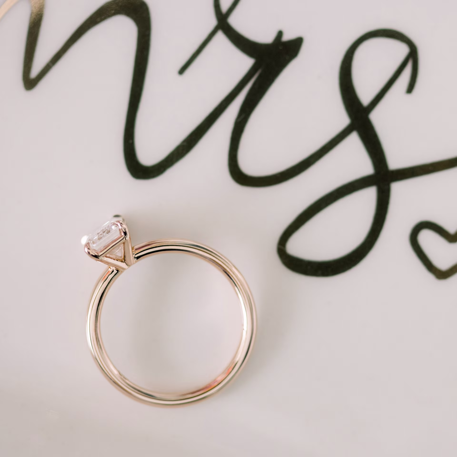 rose gold lab created emerald cut ring