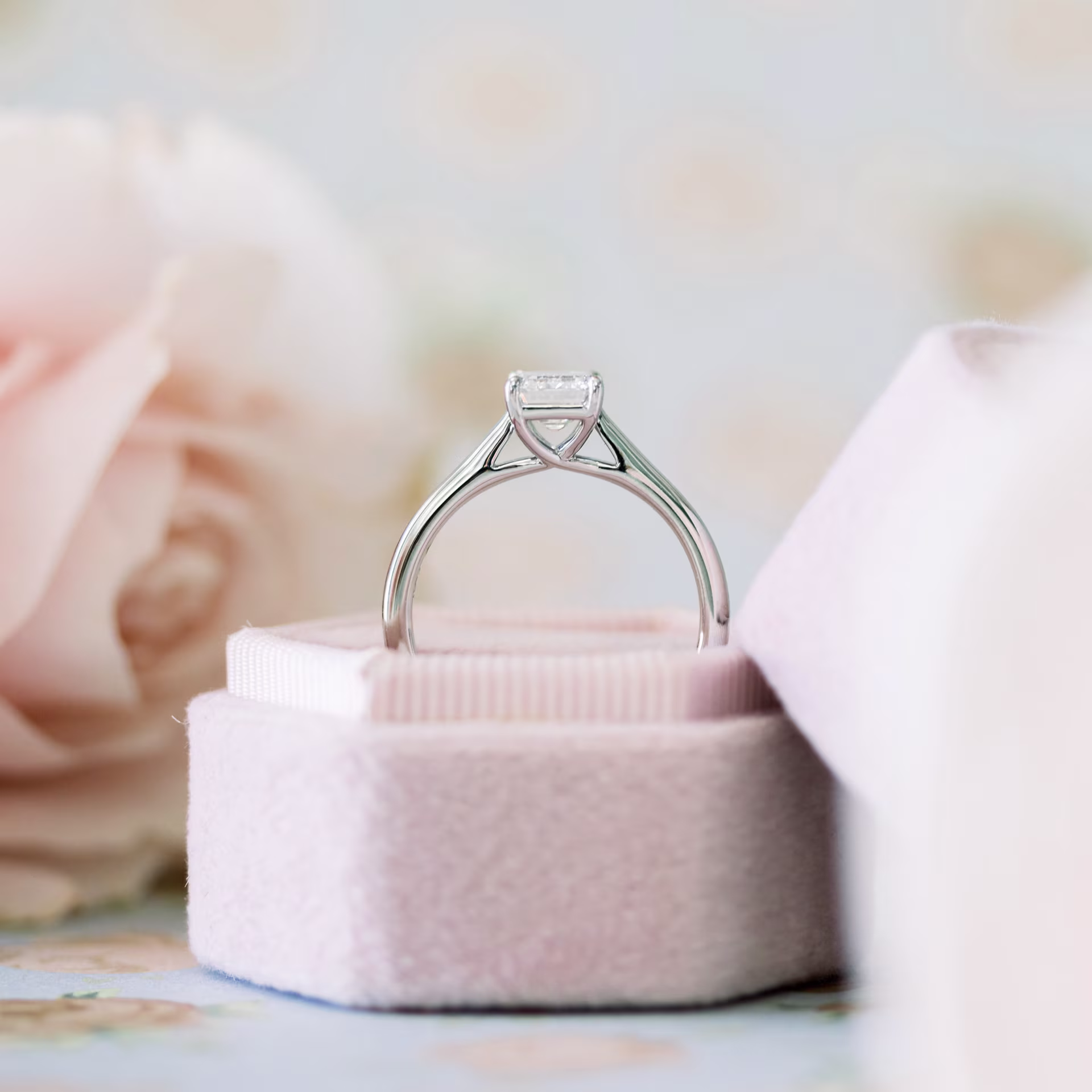 platinum trellis setting with emerald cut center stone