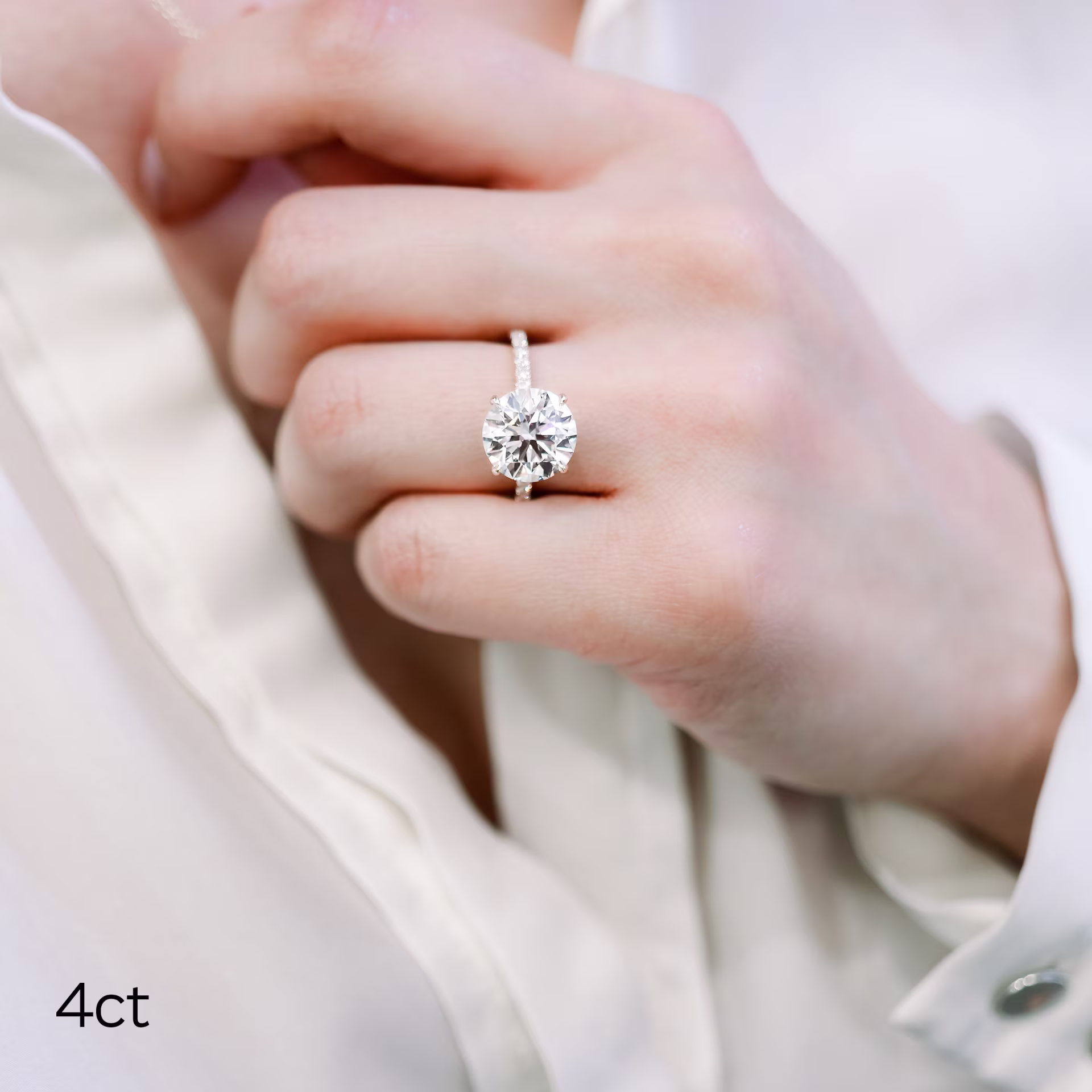 4ct round lab diamond in four prong pave setting