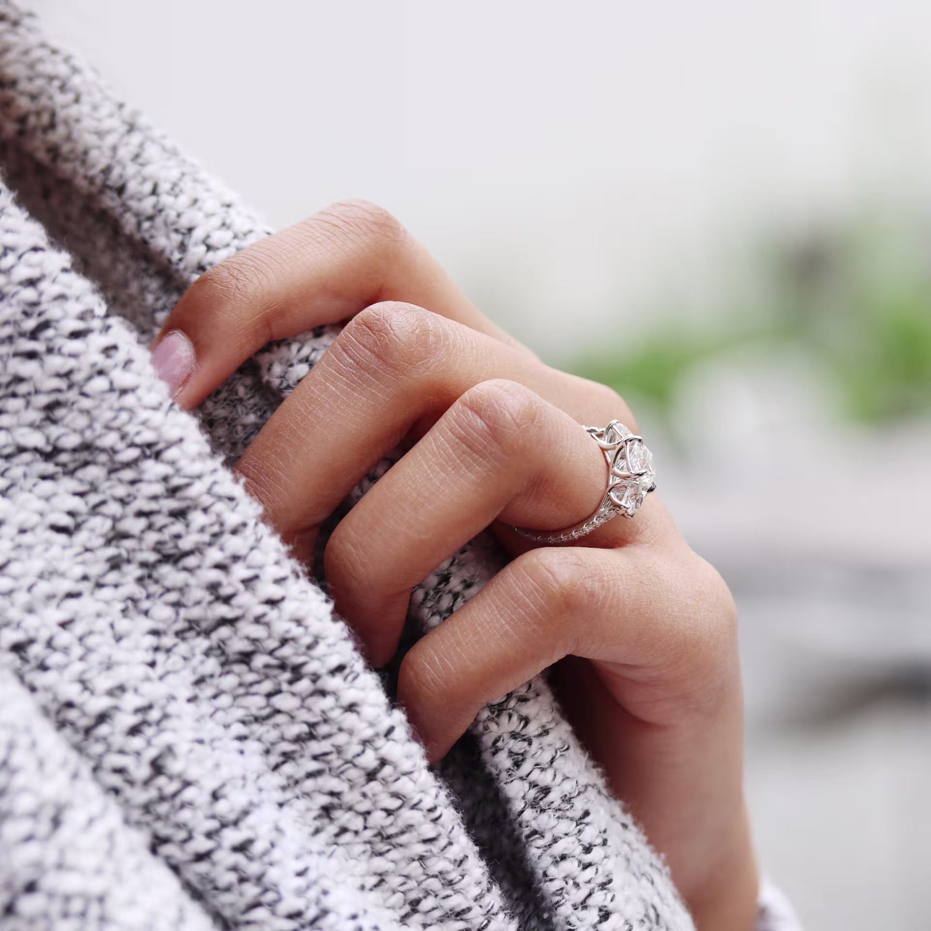 2ct oval lab grown diamond with two round side stones and pave band