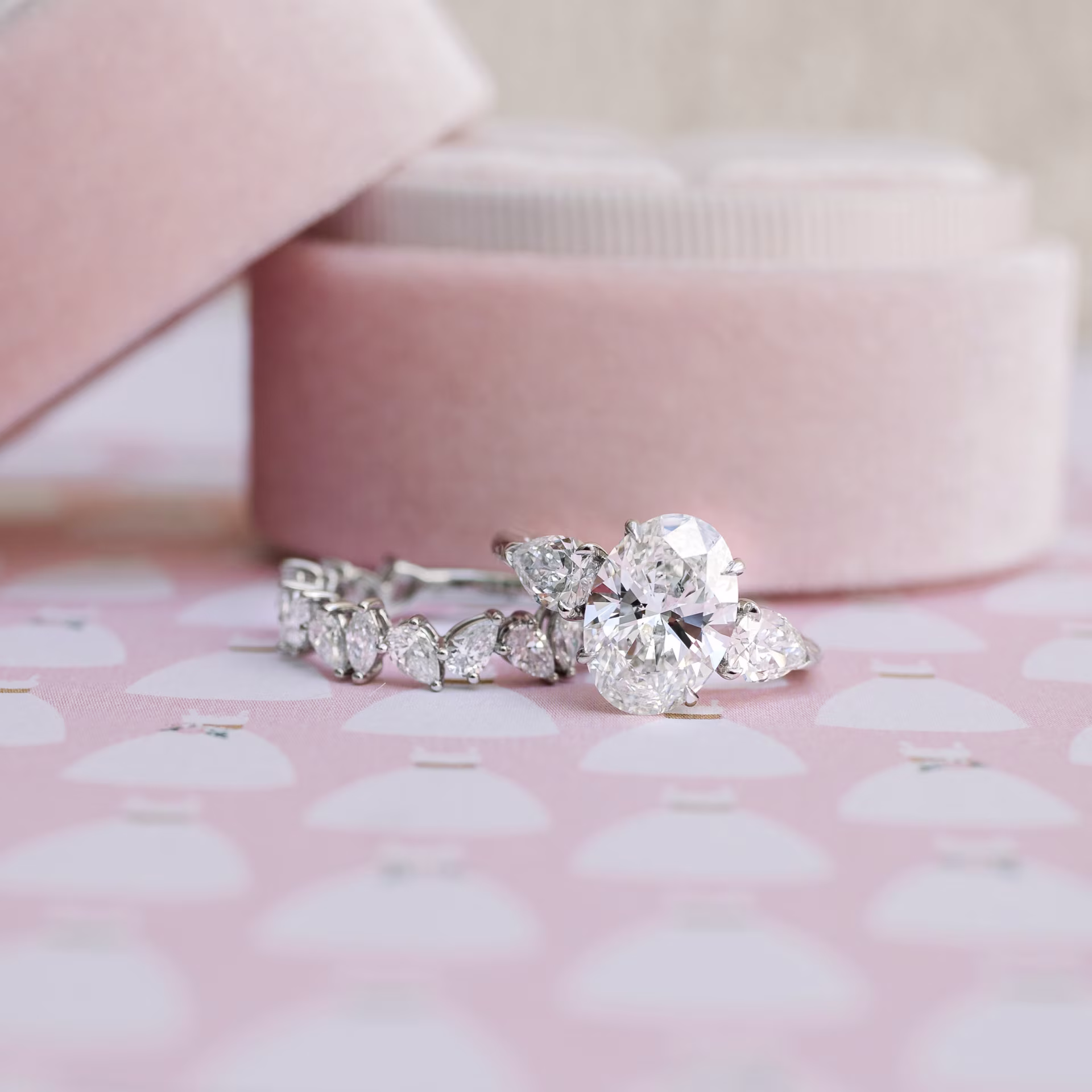 white gold oval and pear engagement ring featuring lab created diamonds with custom lab grown diamond pear cluster wedding band