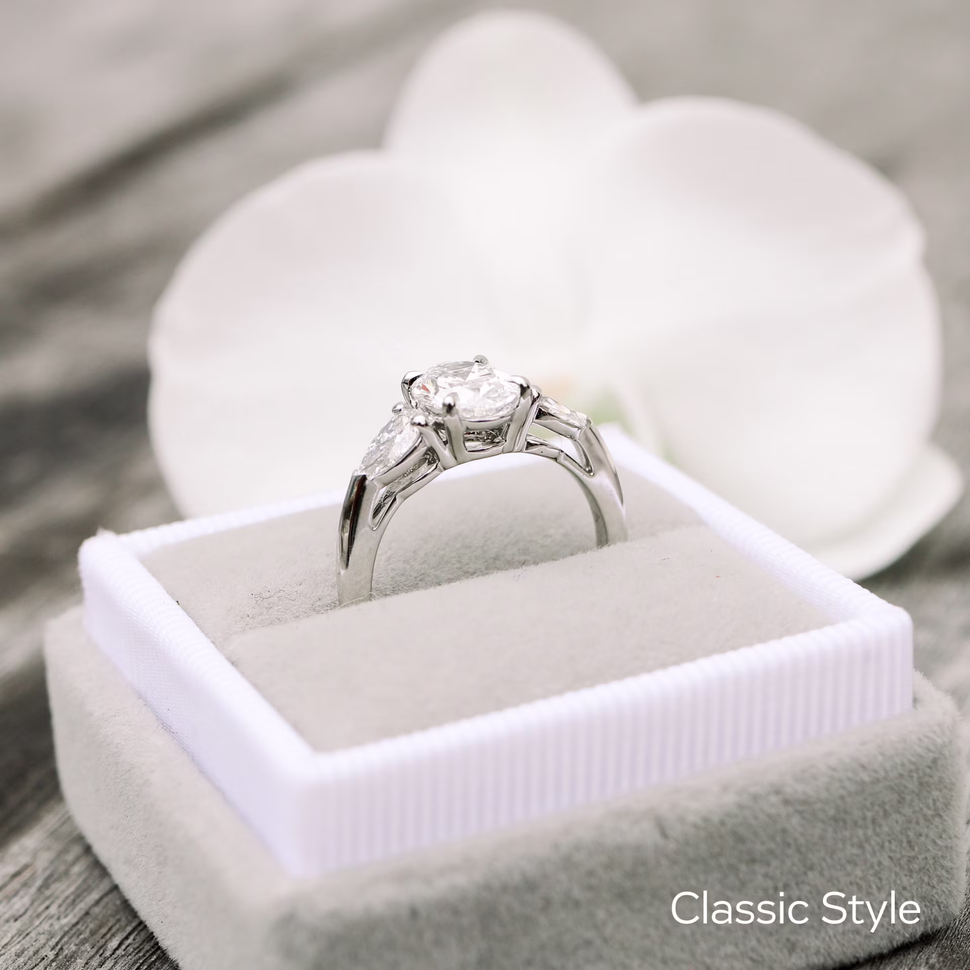 classic white gold oval and pear setting featuring lab created oval diamond center stone and pear side stones