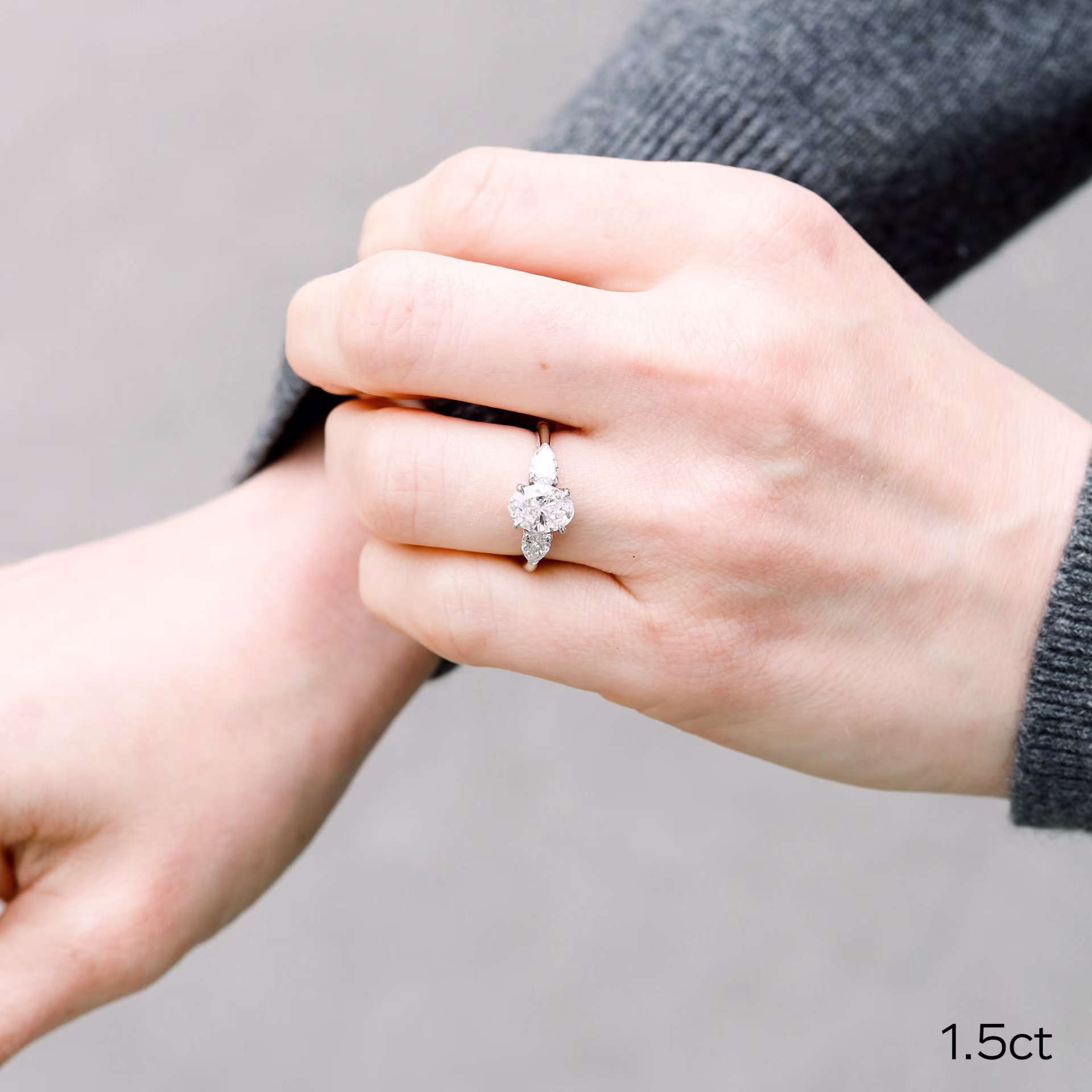 1.5ct lab grown oval diamond with pear side stones set in a 14k yellow gold setting