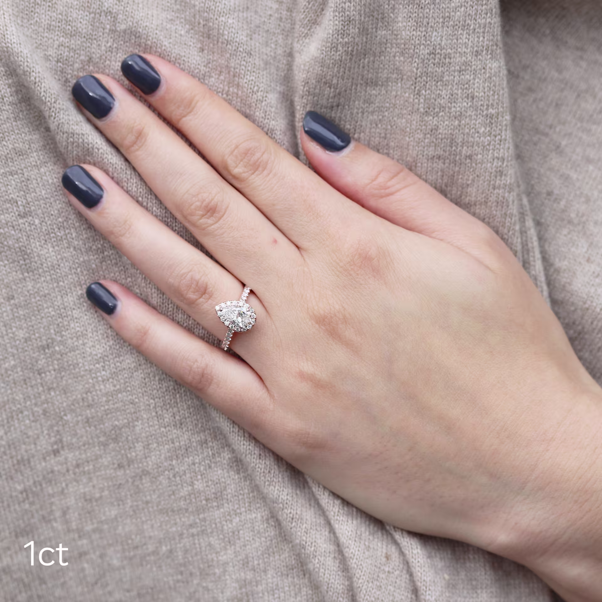 platinum 1ct pear manmade diamond halo ring with pavé diamond band ada diamonds design ad-304 on model