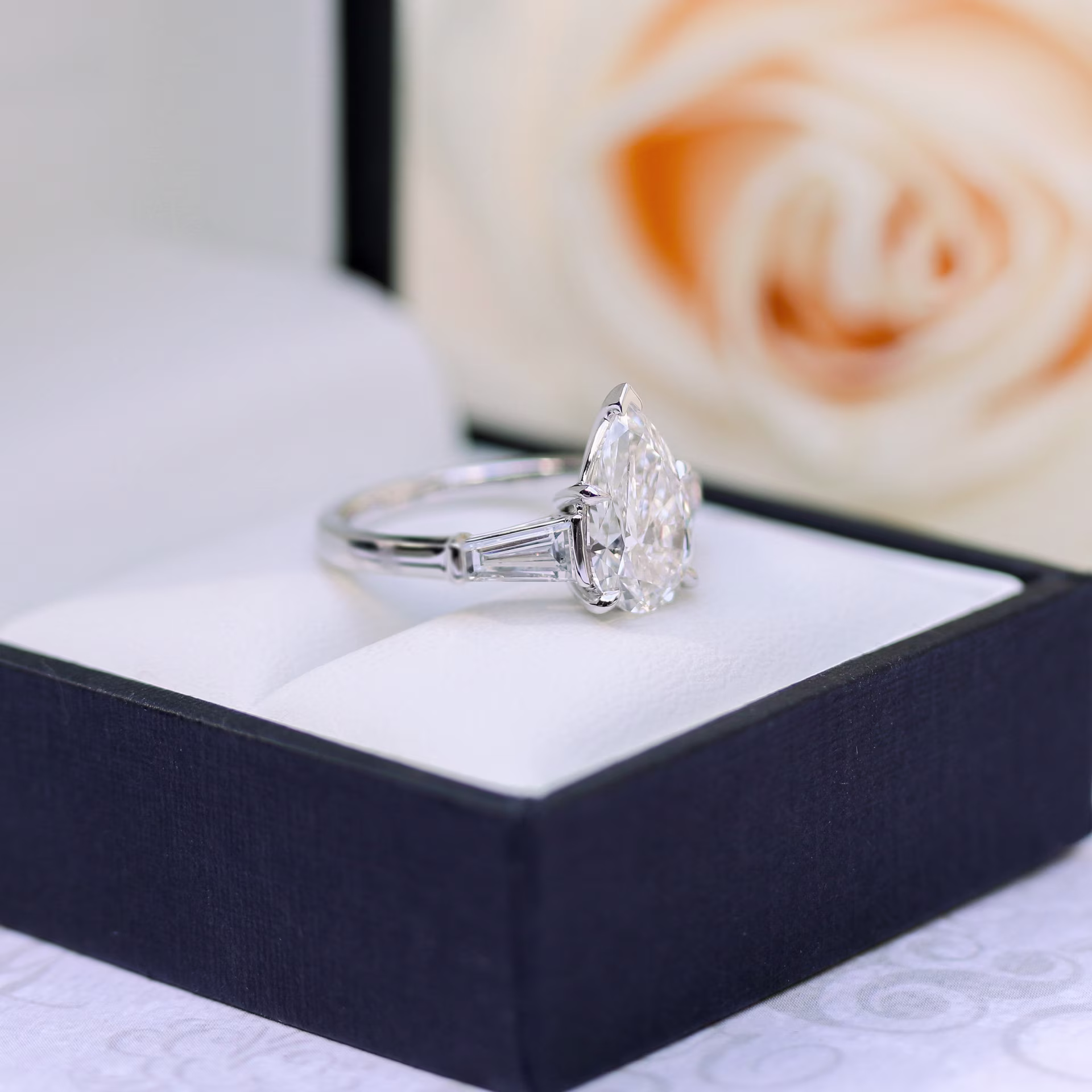 pear and baguette three stone ring in white gold