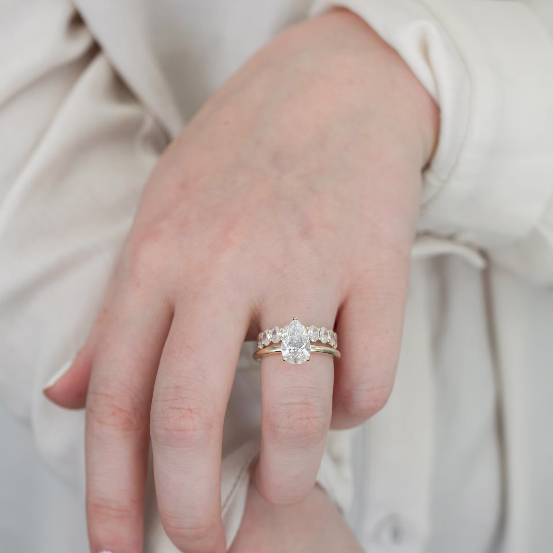 2ct pear solitaire with oval wedding band yellow gold ada diamonds design ad 193 and ad 187 on model