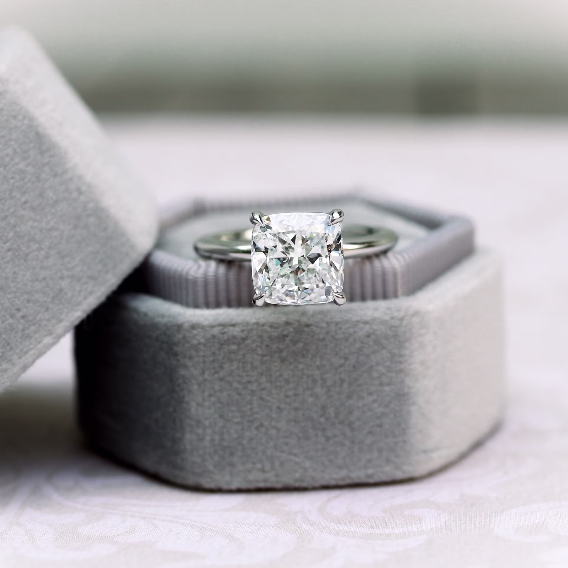 Platinum 2.5 Carat Cushion Cut Man Made Diamond Solitaire Engagement Ring in Platinum Ada Diamonds Design Number AD-221 Artistic Image in Velvet Box