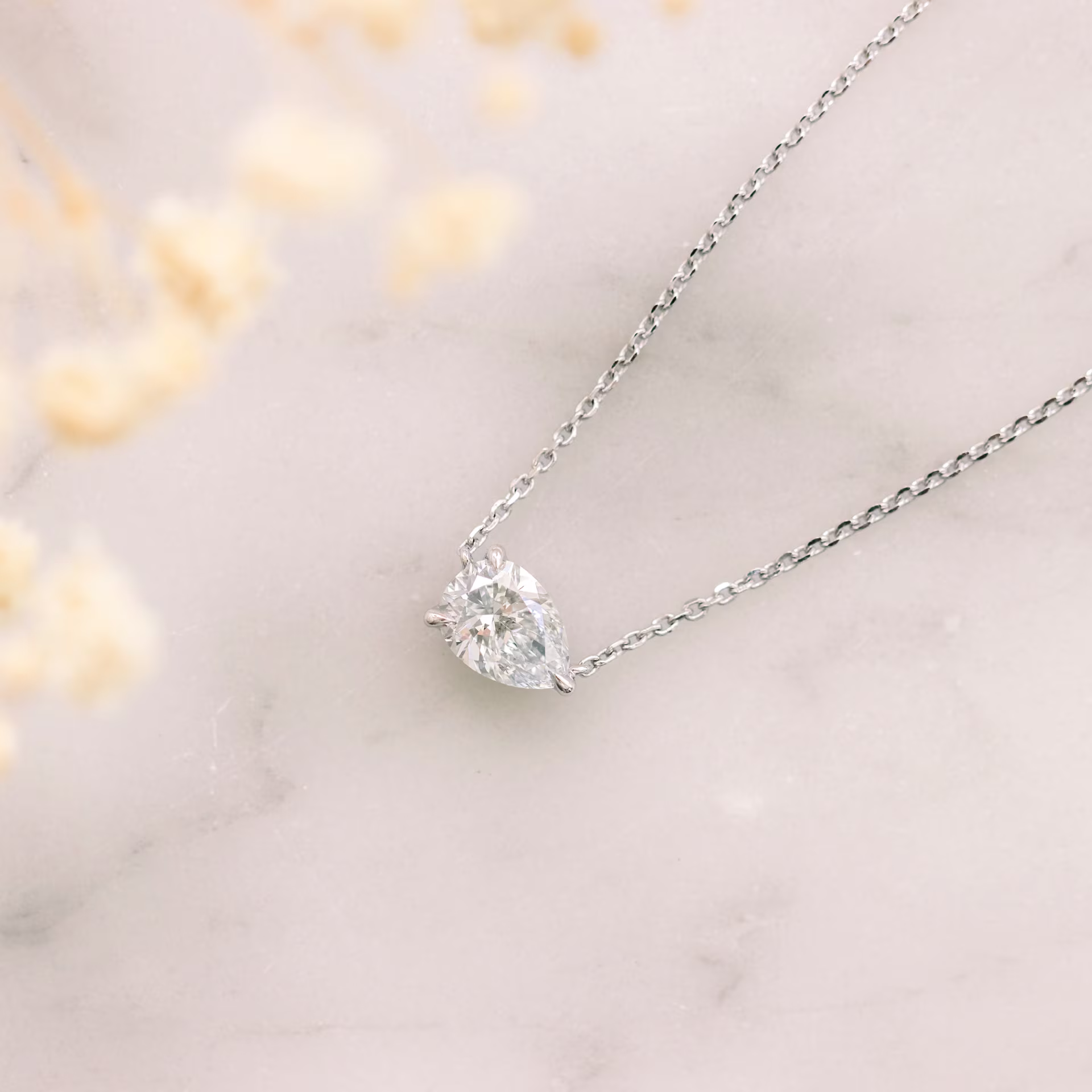 floating pear pendant with half carat in white gold