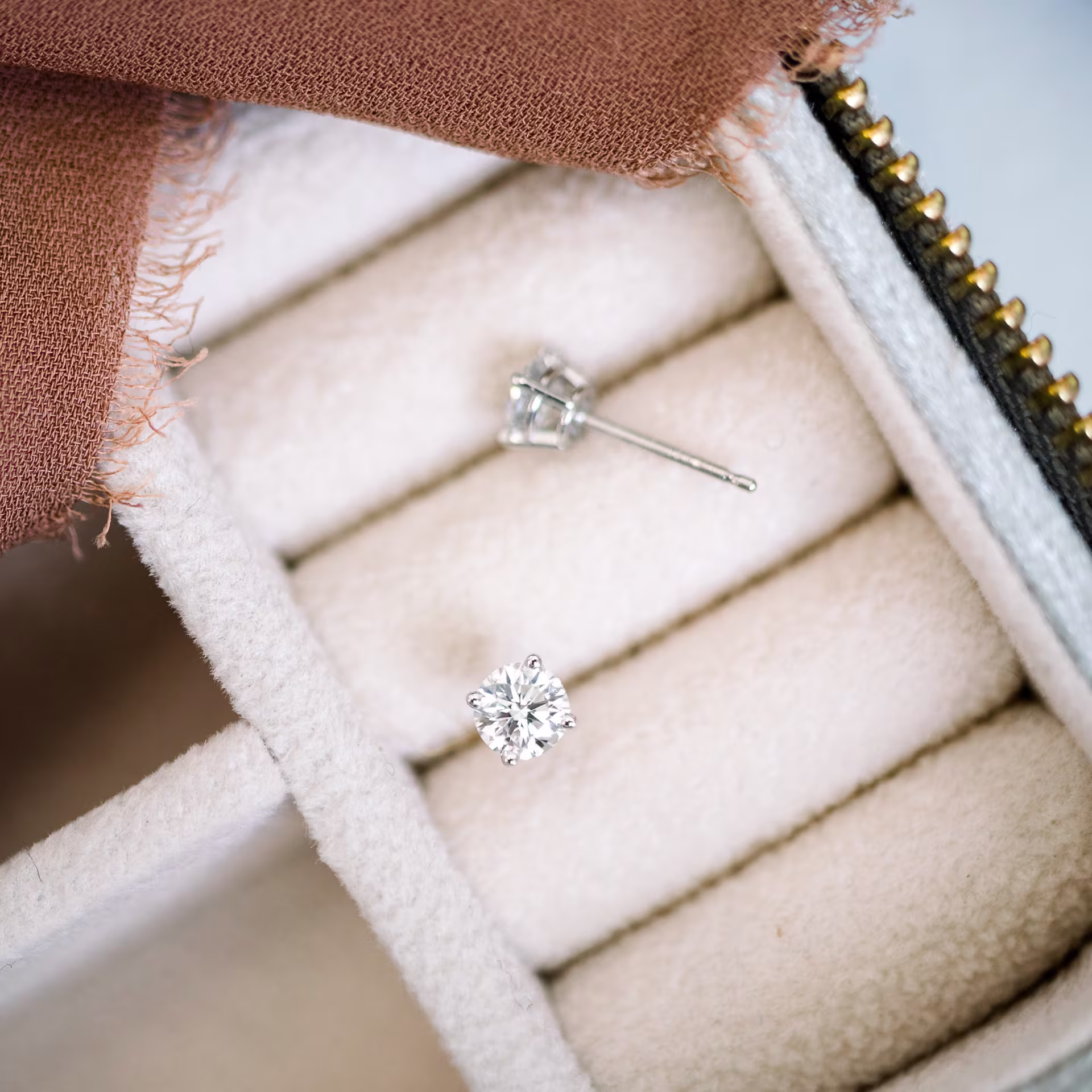 0.7ctw Round Stud Earrings in 14k White Gold in a jewelry box.