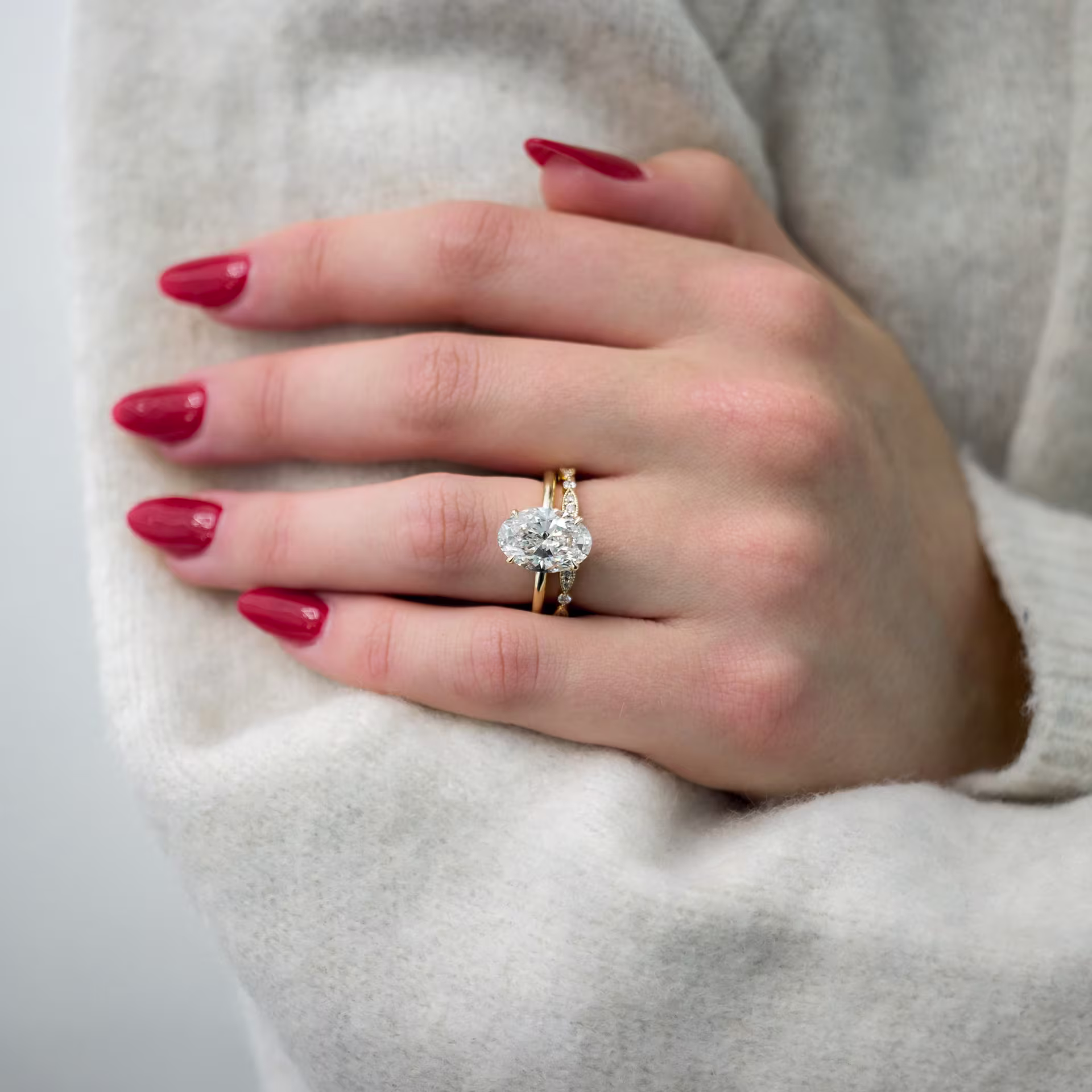 yellow gold 4ct oval lab diamond solitaire engagement ring with leaf wedding band ada diamonds design ad143 and ad216 on model