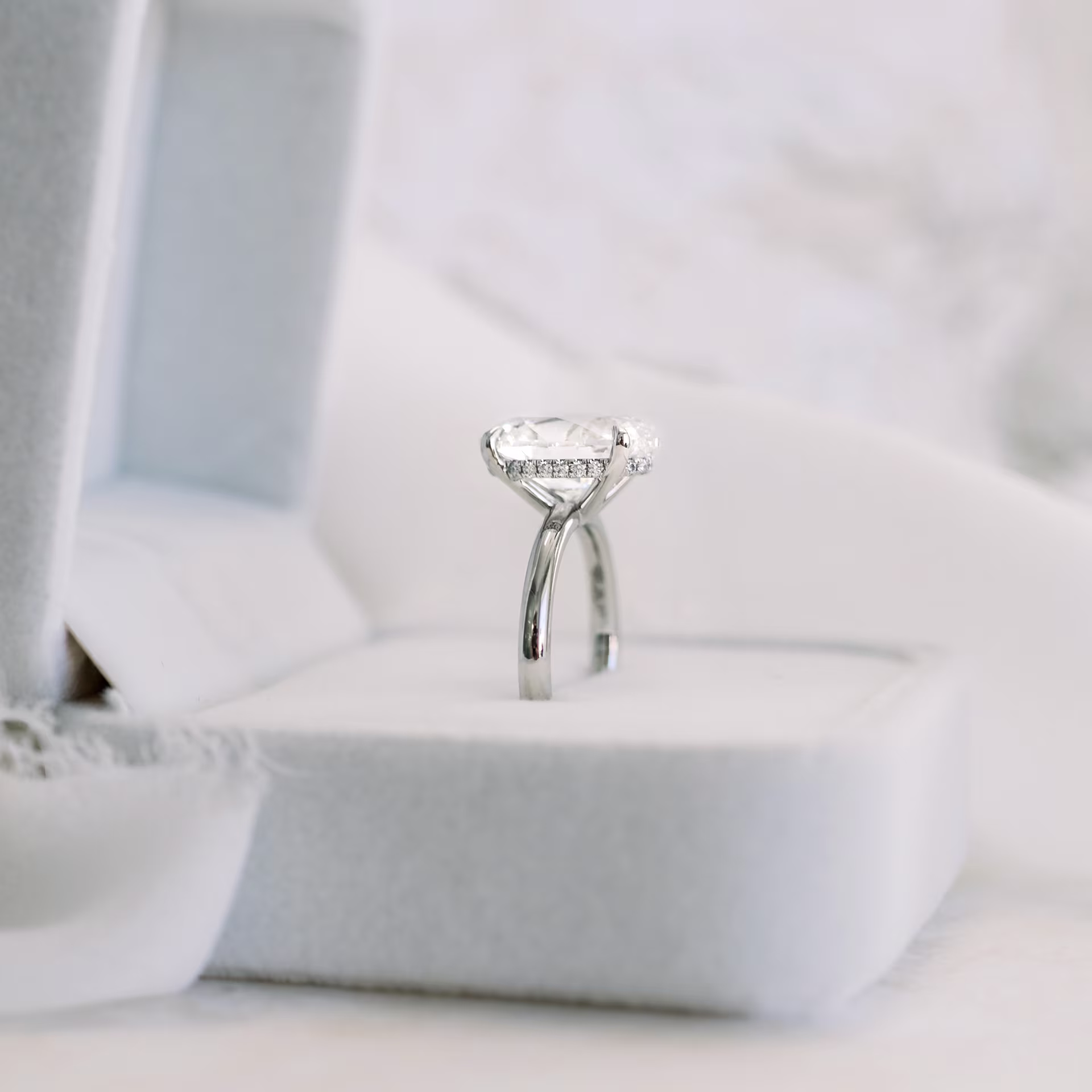 Platinum Oval Petite Four Prong Solitaire Diamond Engagement Ring featuring High Quality 4.25 Carat Diamonds (Side View)