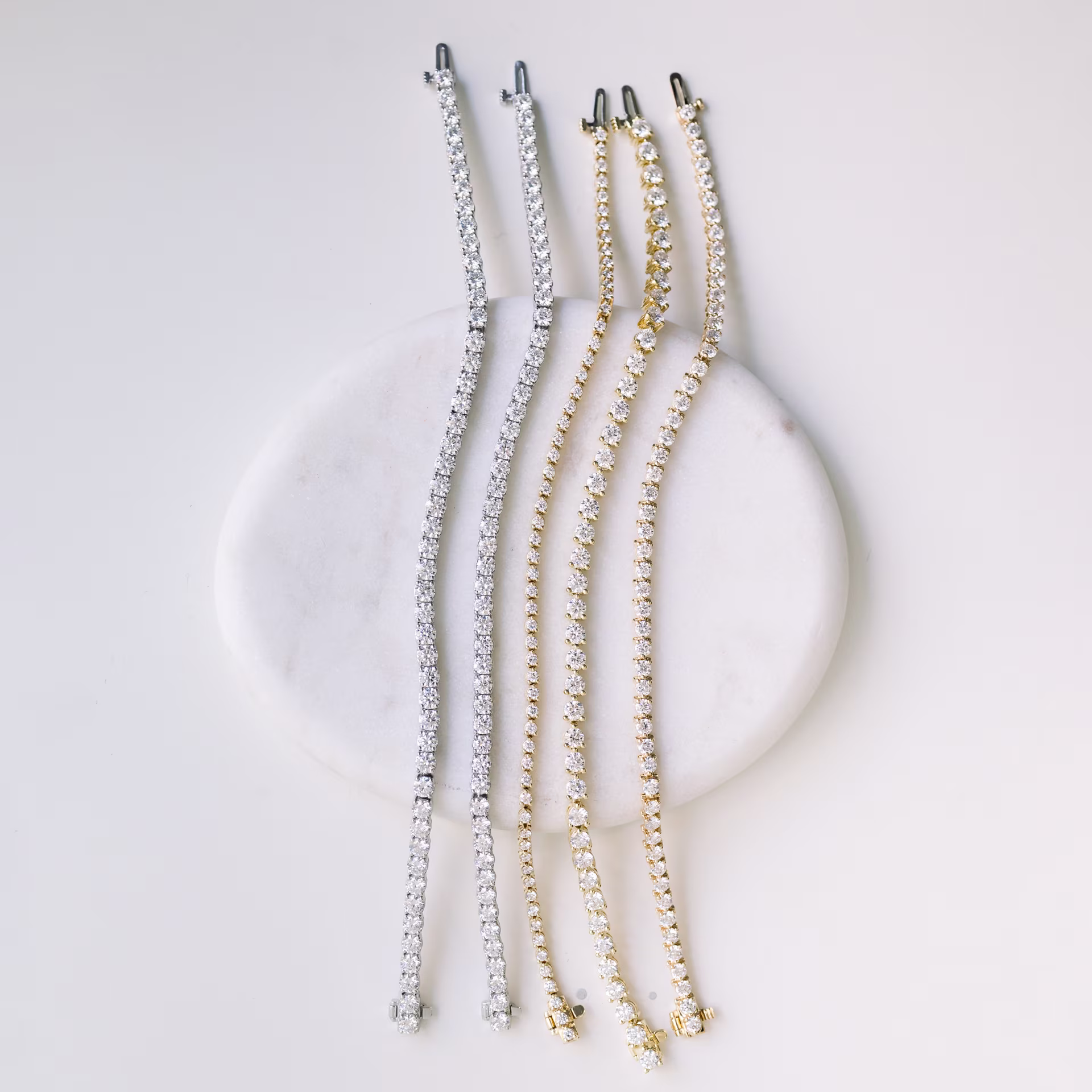 Multiple lab diamond tennis bracelets stacked in white gold
