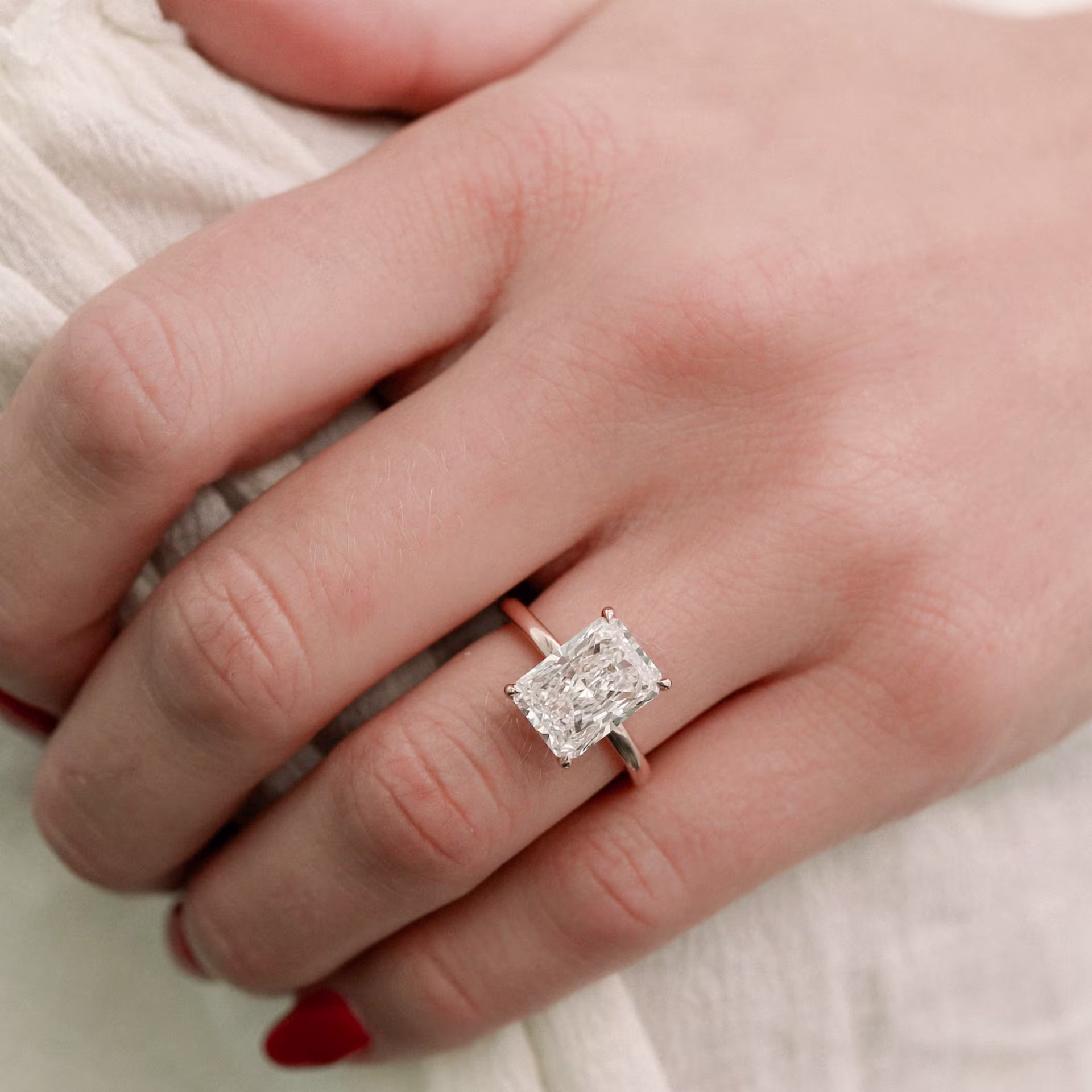 Rose gold round and pear three stone lab diamond engagement ring