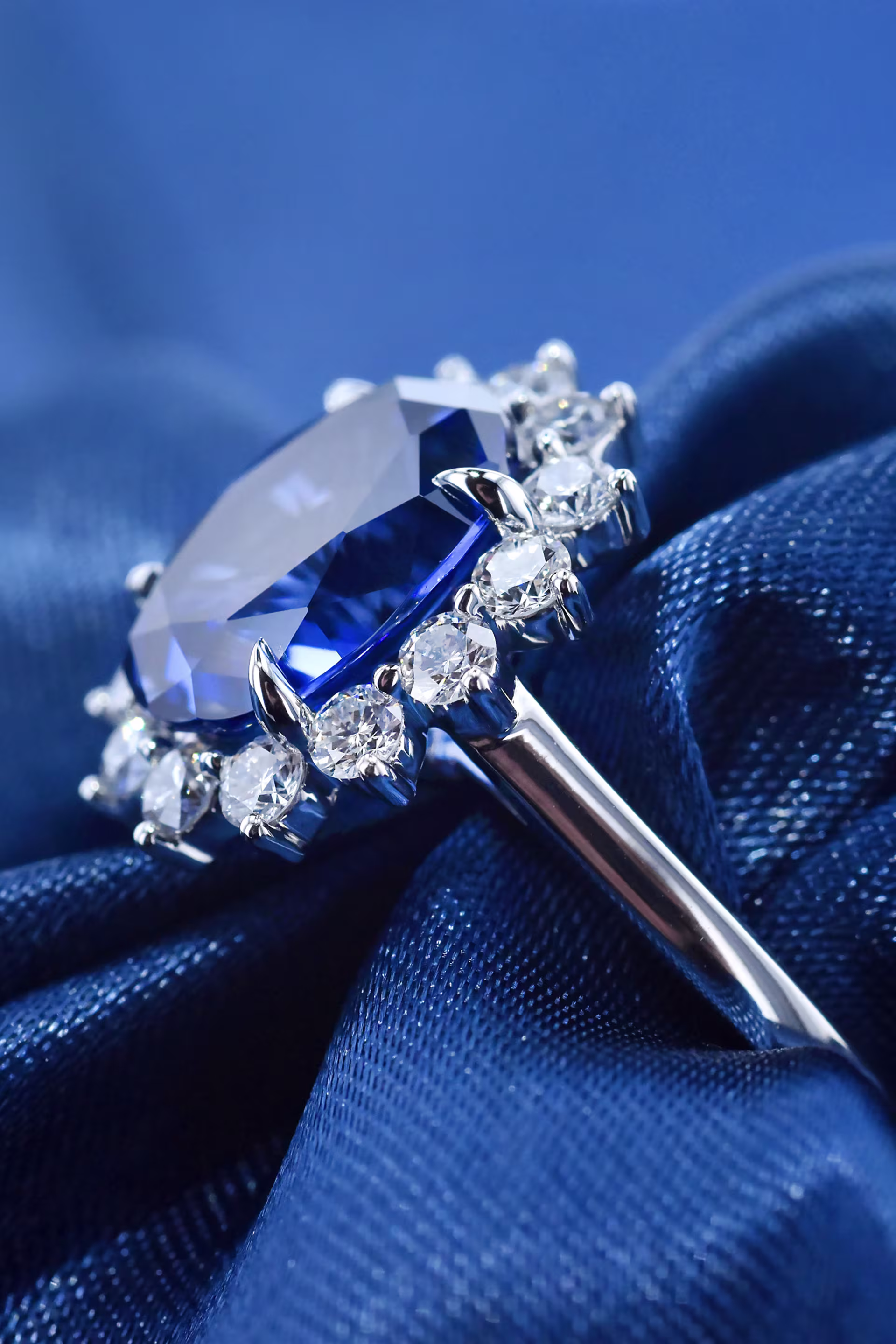 Oval lab grown sapphire engagement ring with a custom floral halo. 