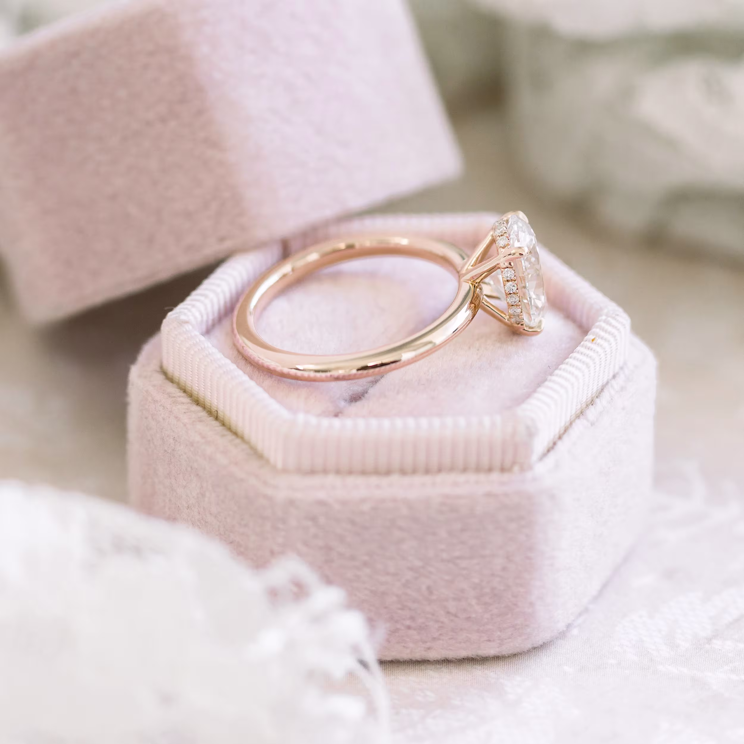 High Quality 2.0 ct Man Made Diamonds Oval Petite Four Prong Solitaire in Rose Gold (Side View)