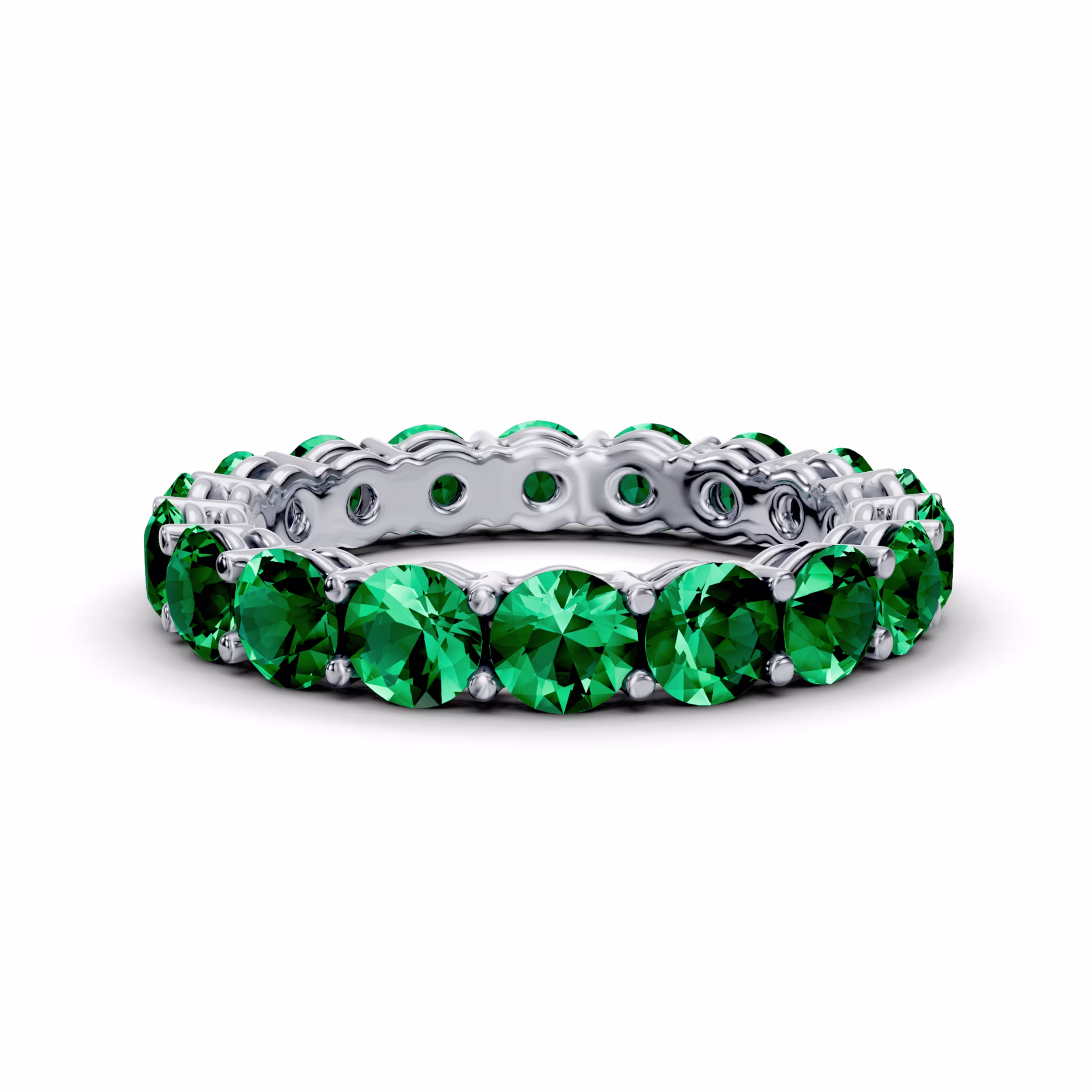 Platinum round emerald prong set eternity band in white metal, featuring melee stones
