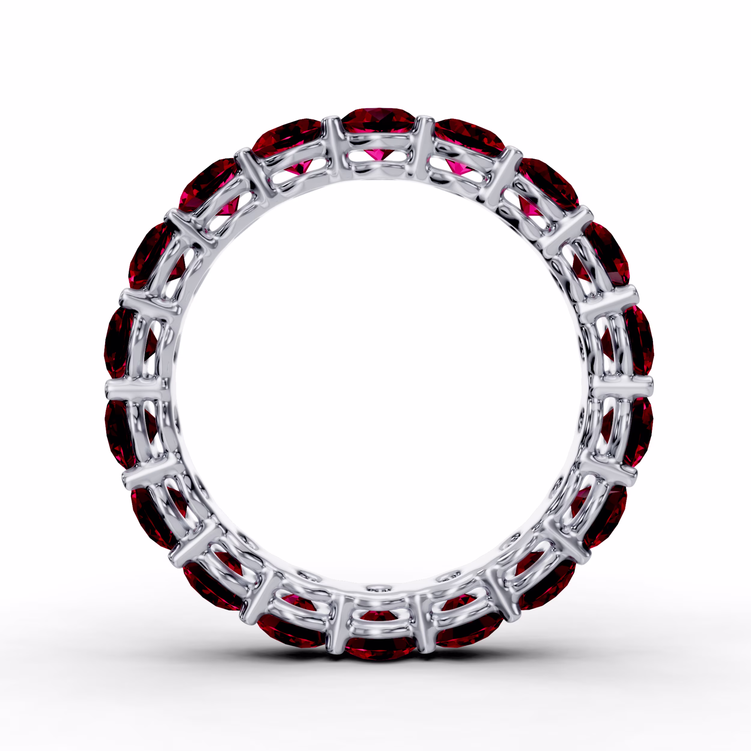 Platinum round ruby prong set eternity wedding band in white metal featuring melee stones.