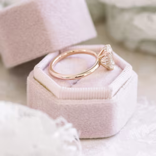 High Quality 2.0 ct Man Made Diamonds Oval Petite Four Prong Solitaire in Rose Gold (Side View)