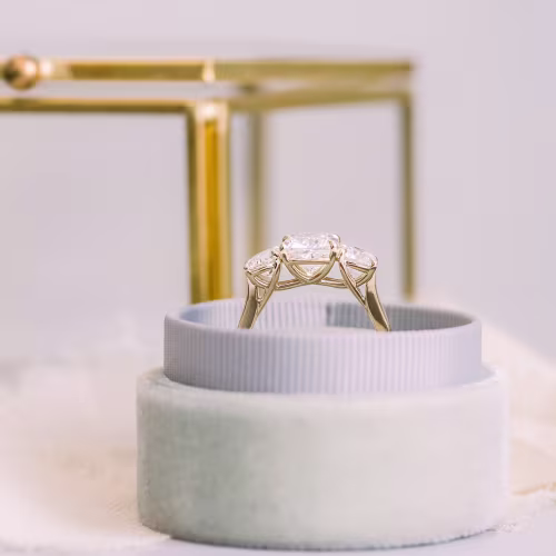 lab created three stone ring with cushion and rounds