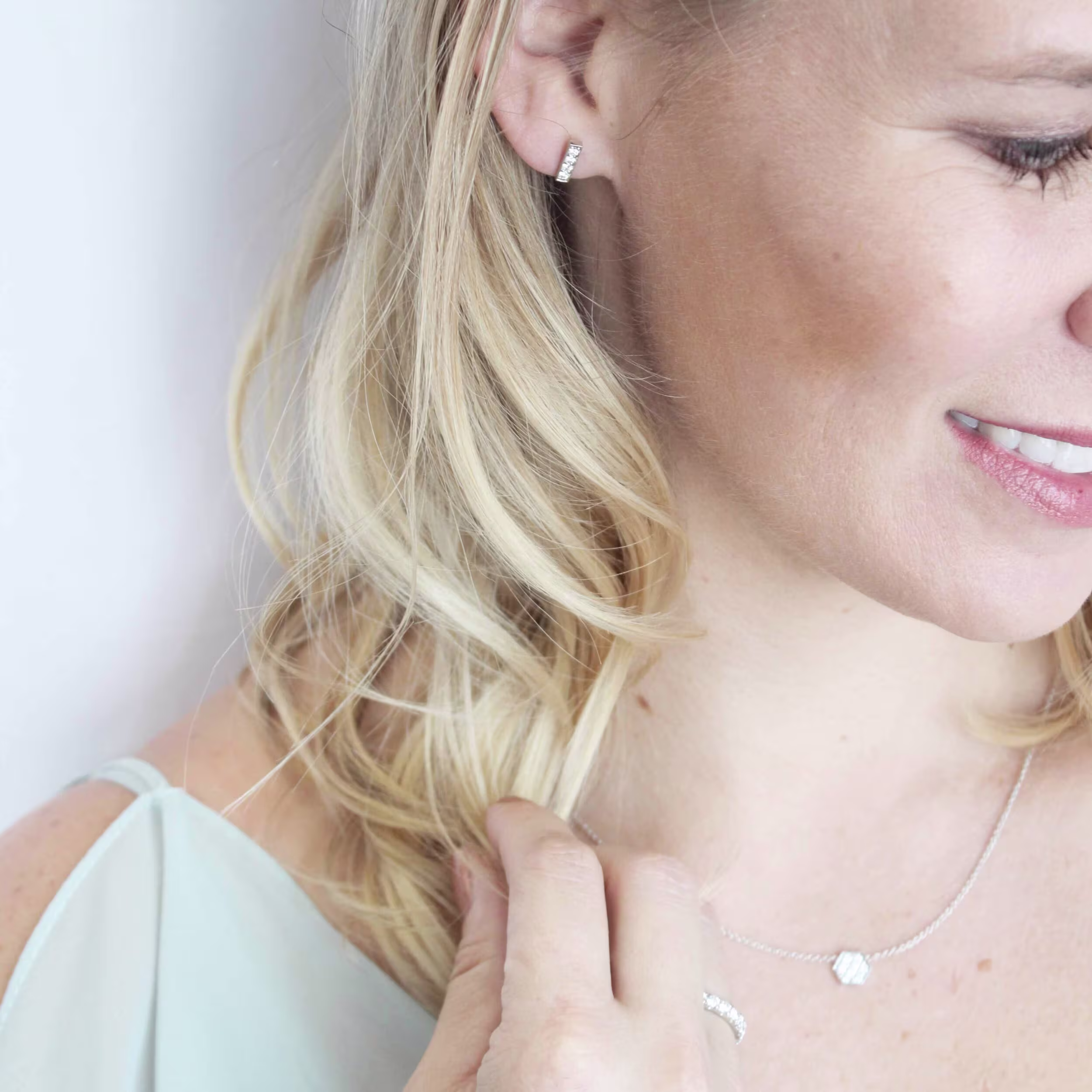 white gold bar drop earrings on model ada diamonds