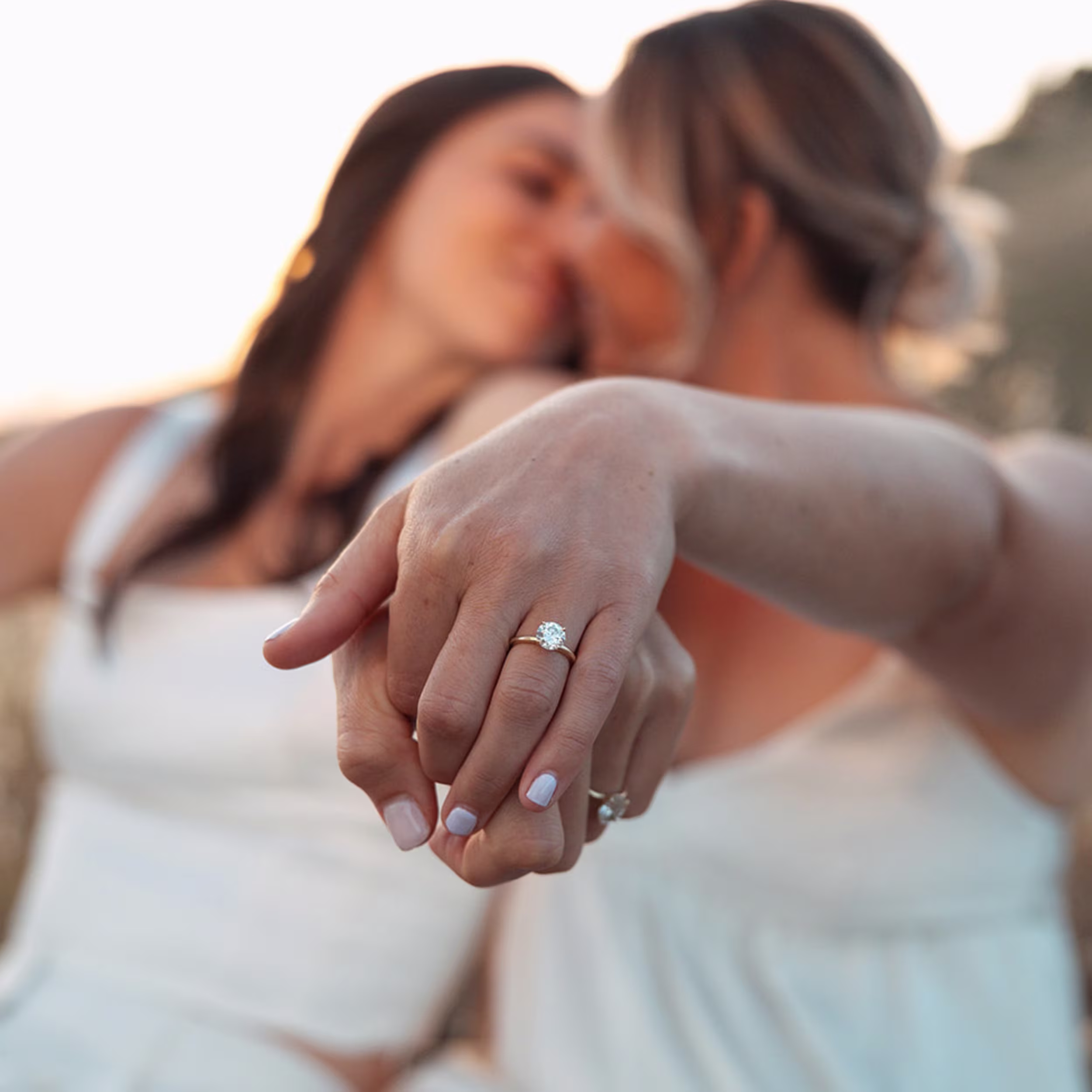 Couple holding hands while wearing a lab-grown diamond engagement ring by Ada Diamonds