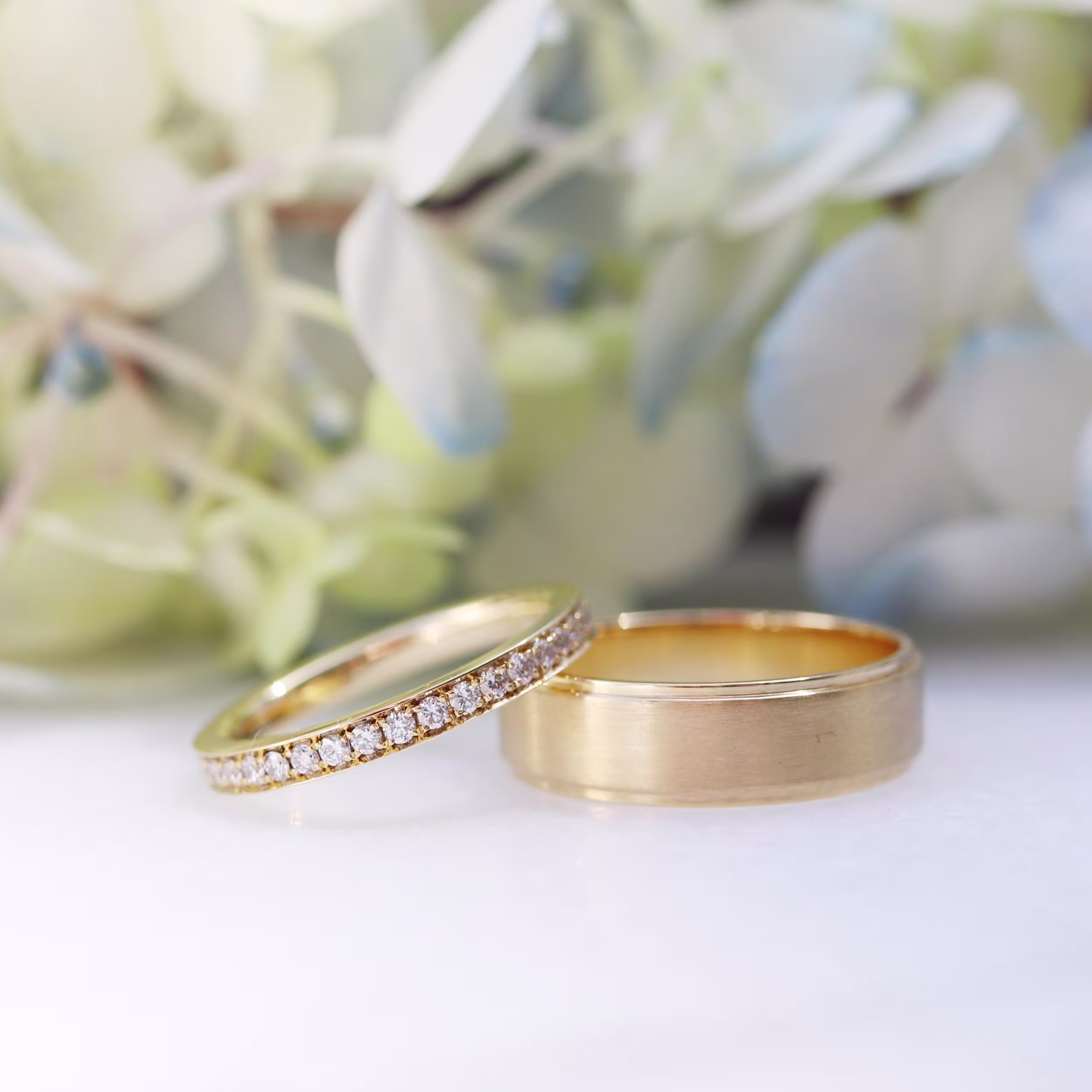 Men's Yellow Gold Matte Flat Beveled Wedding Band and Women's Lab Diamond Half Eternity Band Ada Diamonds Design Number AD-169 Macro Shot