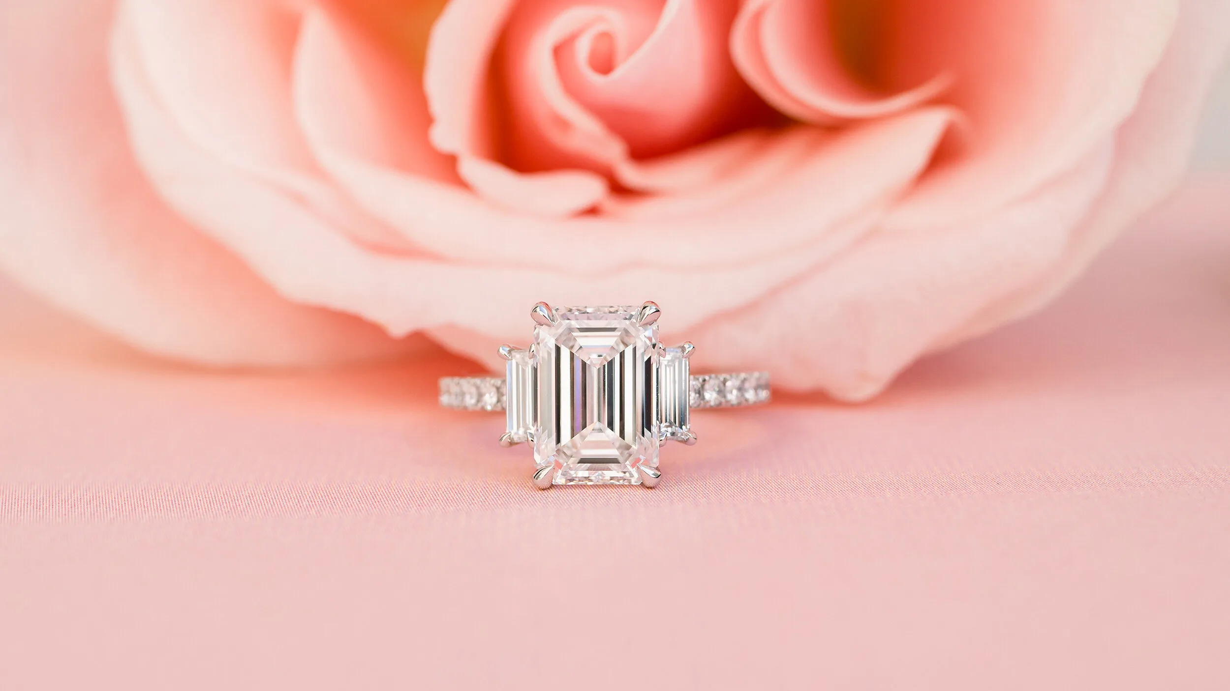 Three Stone Engagement Ring with featuring emerald cut lab diamond in platinum