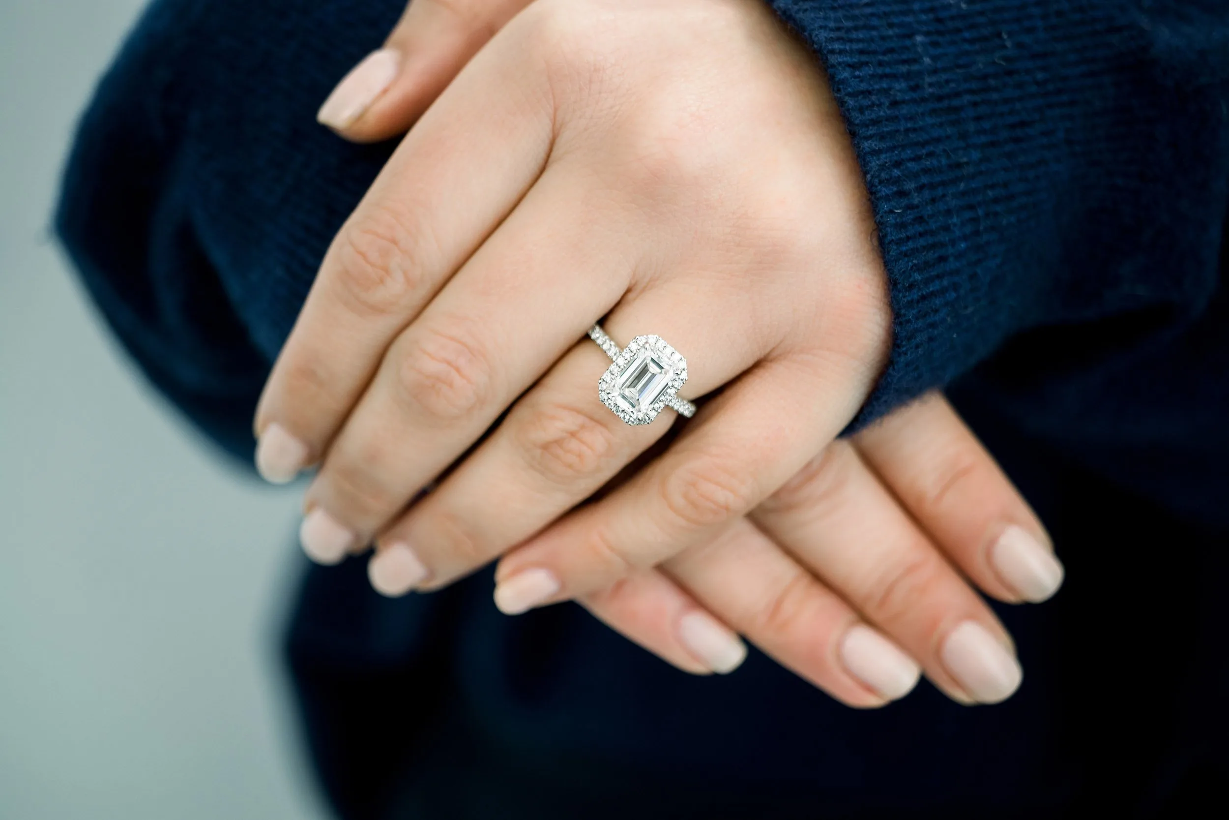 platinum halo engagement ring featuring 2 ct emerald cut lab diamond center stone ada diamonds design ad212 on model