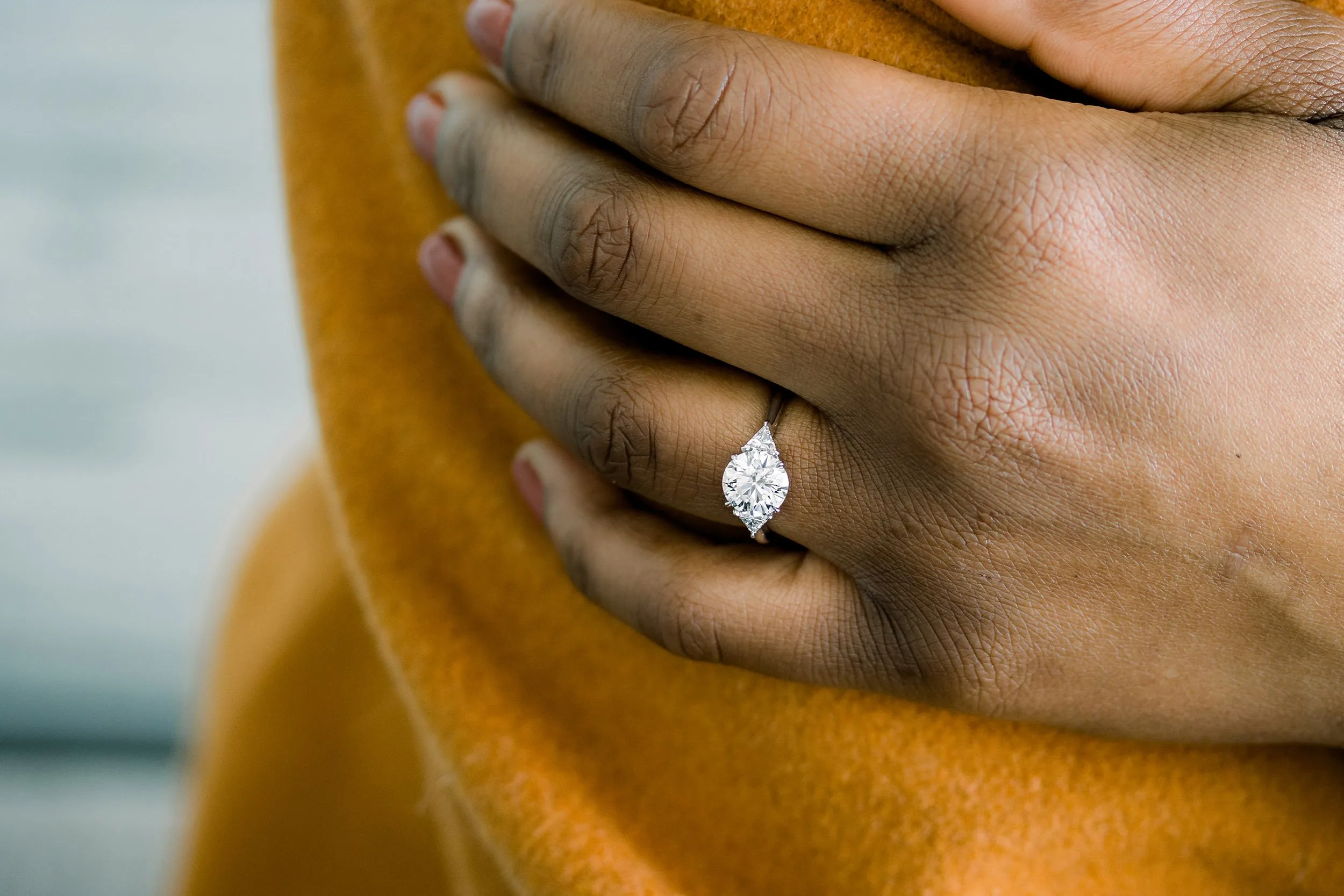 2.5 carat round and trillion lab diamond three stone ring in platinum ada diamonds design ad072 on model