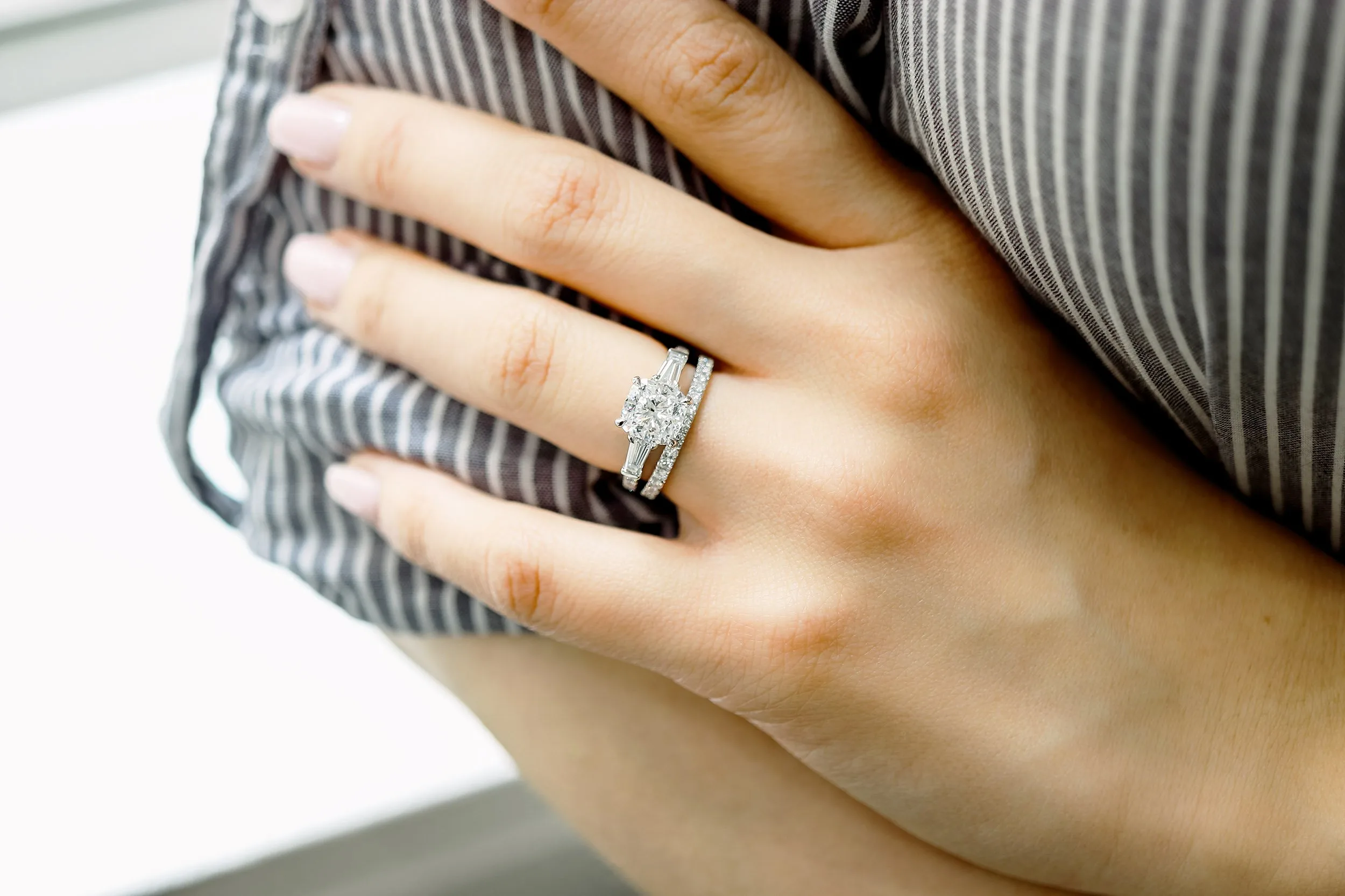 platinum three stone engagement ring with cushion cut