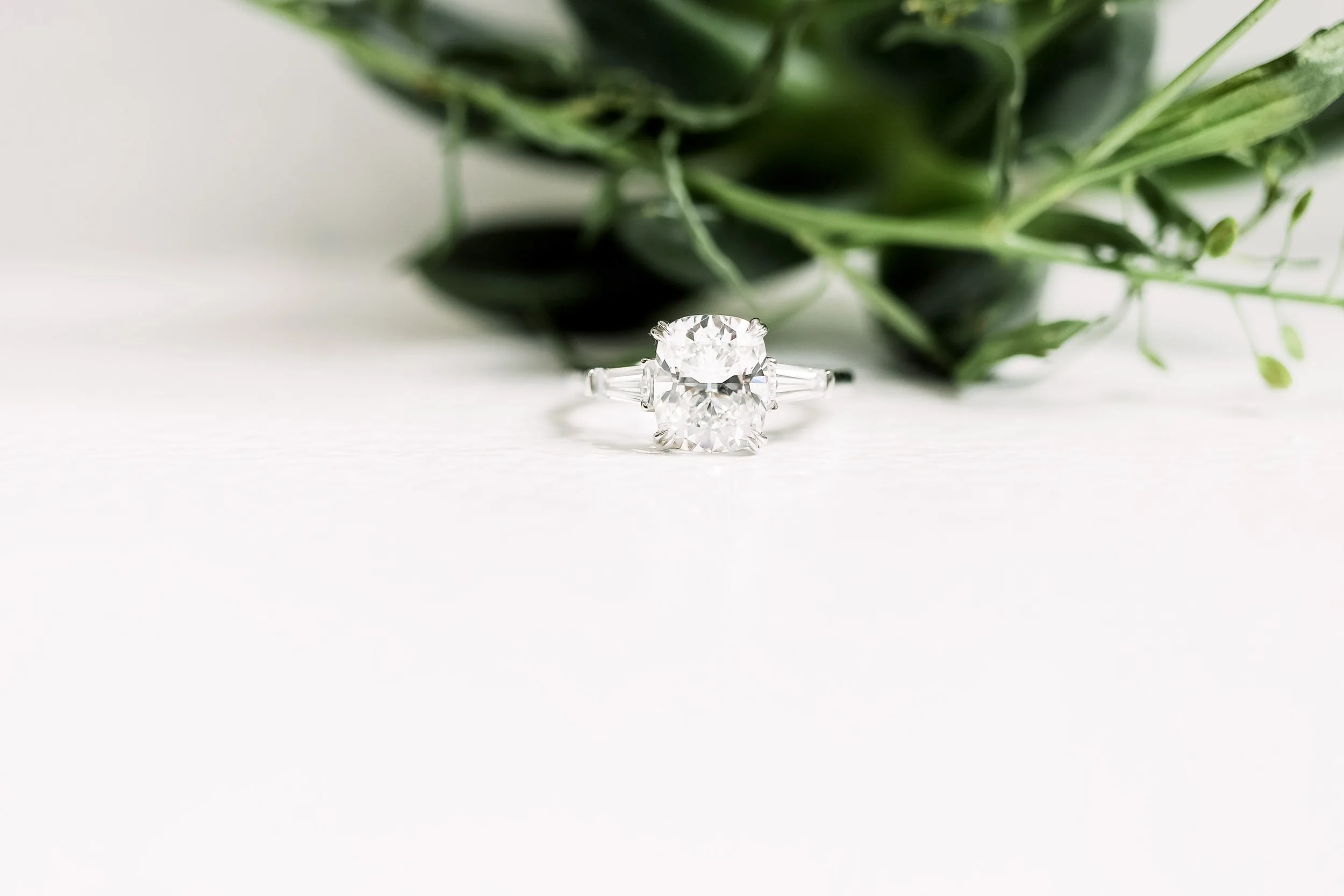 cushion and tapered baguette three stone engagement ring