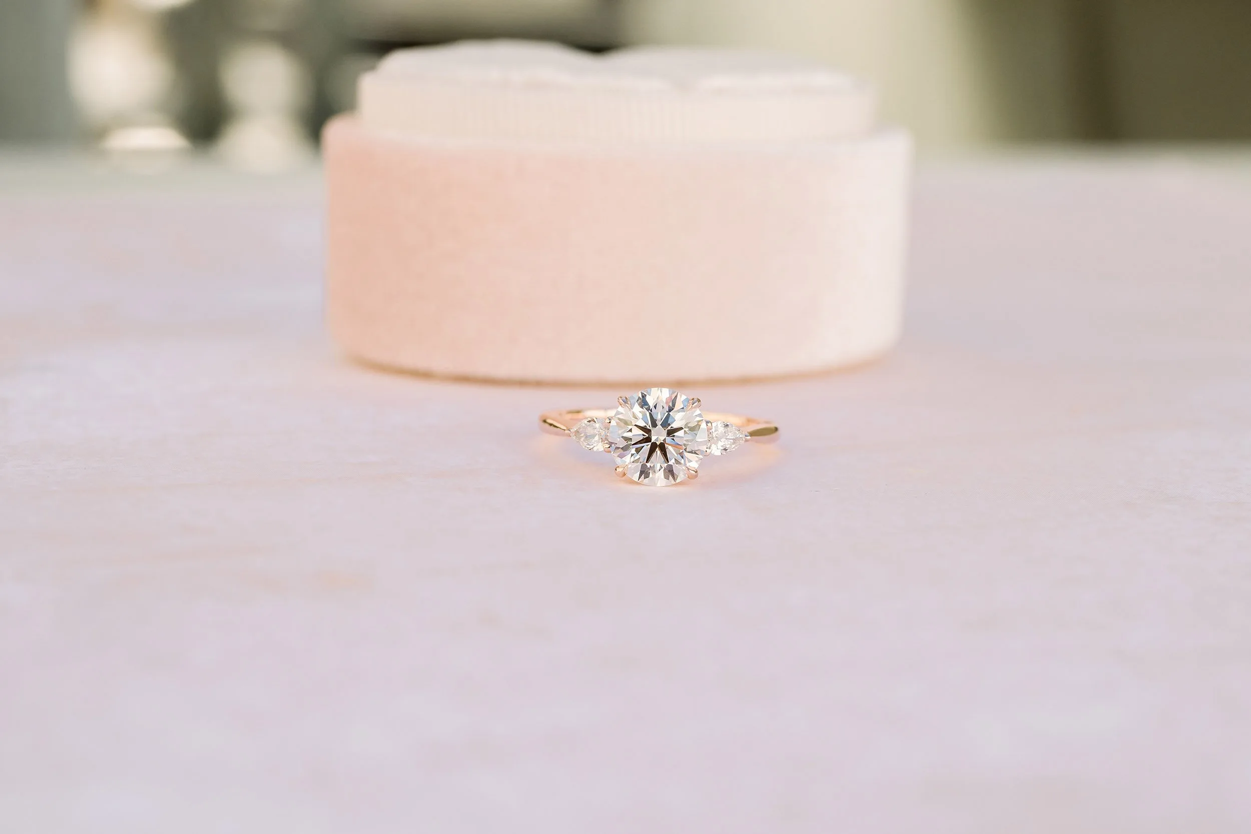 1.5ct round lab diamond with pear side stones in rose gold