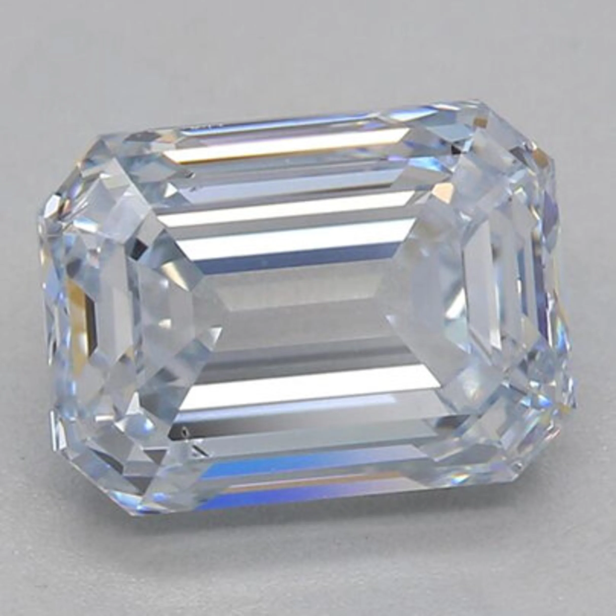 An HPHT grown emerald cut with blue nuance. This diamond received an H color grading from IGI.